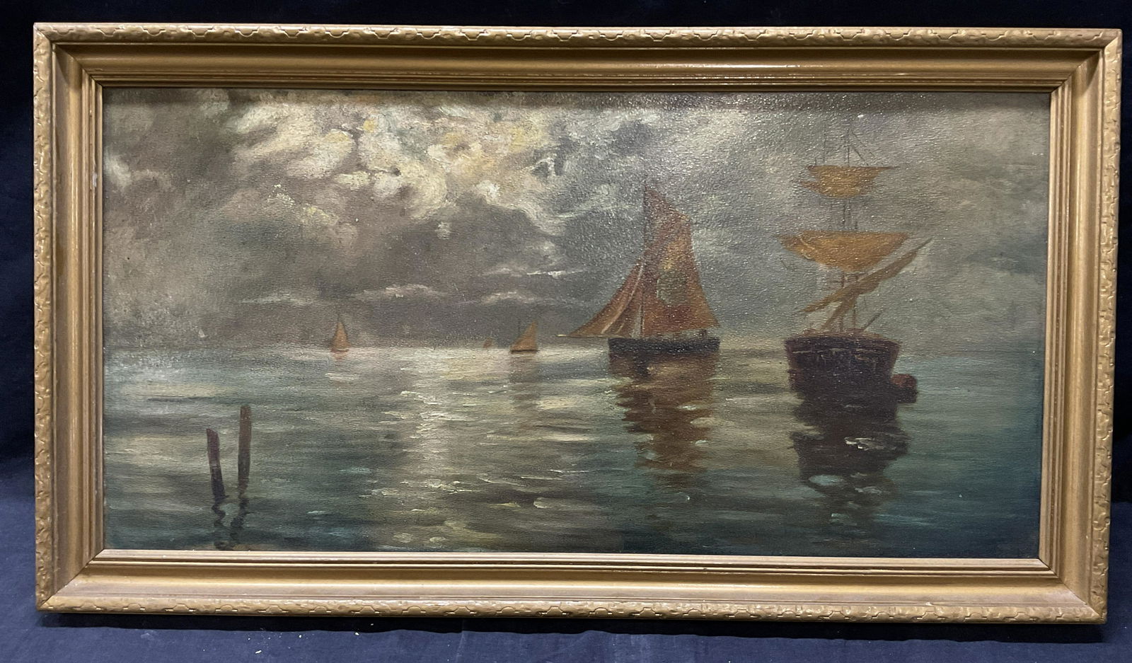 Framed Nautical Ship Oil Painting on Board: Nautical Ship Oil Painting on Board. Framed in a wooden gold toned painted frame. Whole measures approx 26.5 x 14.5 inches. Window within frame measures approx 23.5 x 11,5 inches. Surface wear to piec