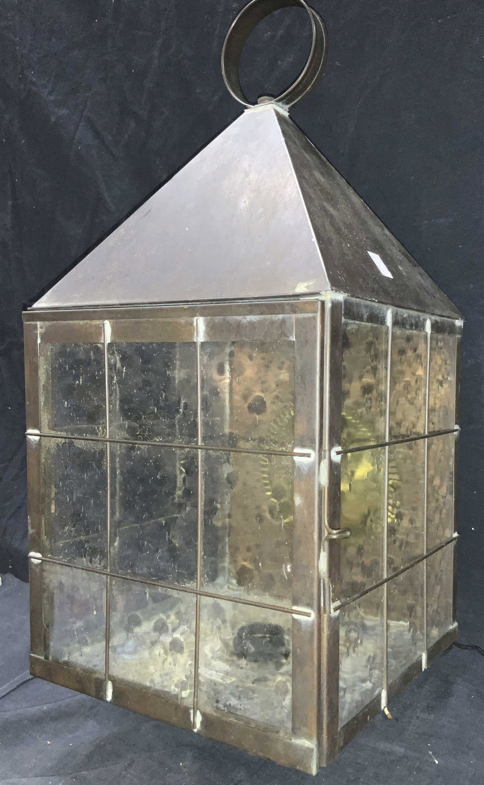 XL Nantucket Brass Wall Lamp 1ft10in: Approximately 22 inches tall, wall Mount Nantucket style lamp with clear glass walls and made of patina brass. Comes with Hurricane glass. Marked on backside sticker, wall mount only. Evident wearing 