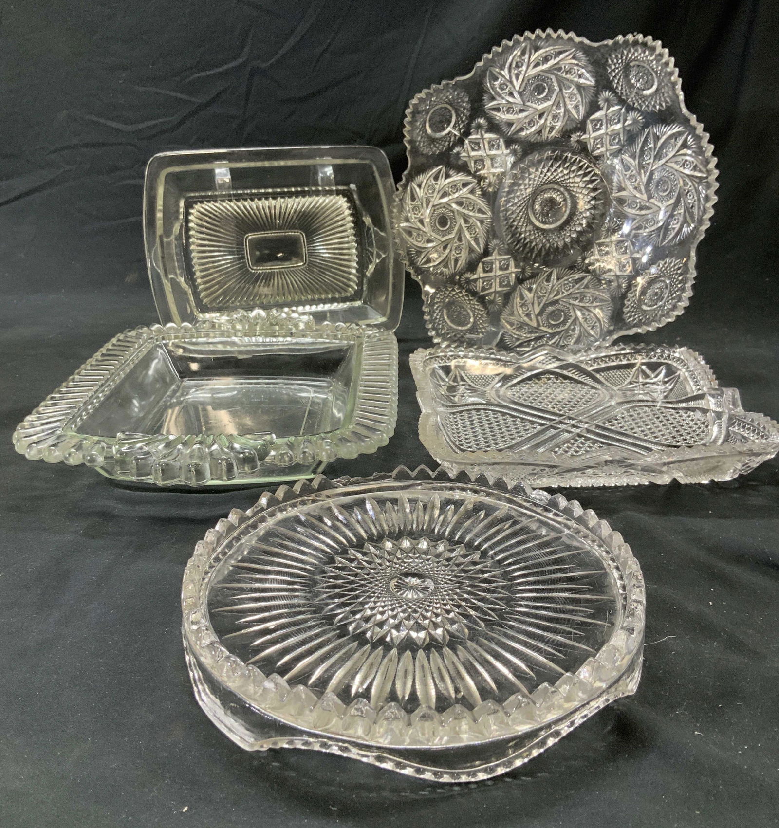 Lot 5 Mid Century Glass Tableware: Hand Cut Sawtooth serving plates with decorative shapes , round plate measures 10 x 1.25 in. Square plate measures 8 x 8 in. Round sawtooth cake or dessert platter, 7.25 in. Pair of rectangular servin