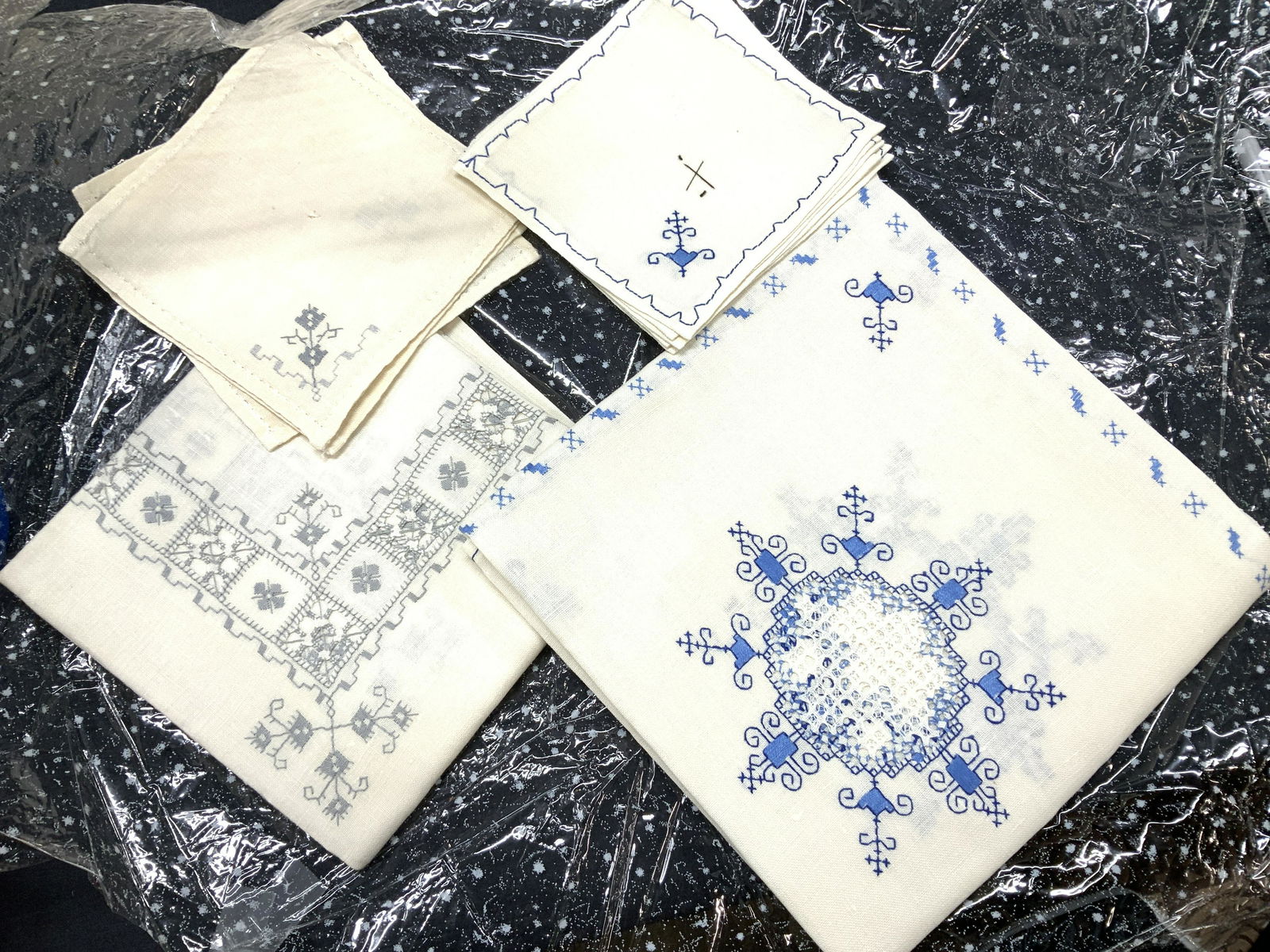 15 Vintage Cross Stitch Linen Tablecloths more NIP: Vintage cross stitch tablecloths with matching square cocktail napkins . 1 set with 6 napkins , 6 x 6 in. Tablecloth 40.5 x 41 in. cream linen with blue stitching . Another set cream linen with grey s