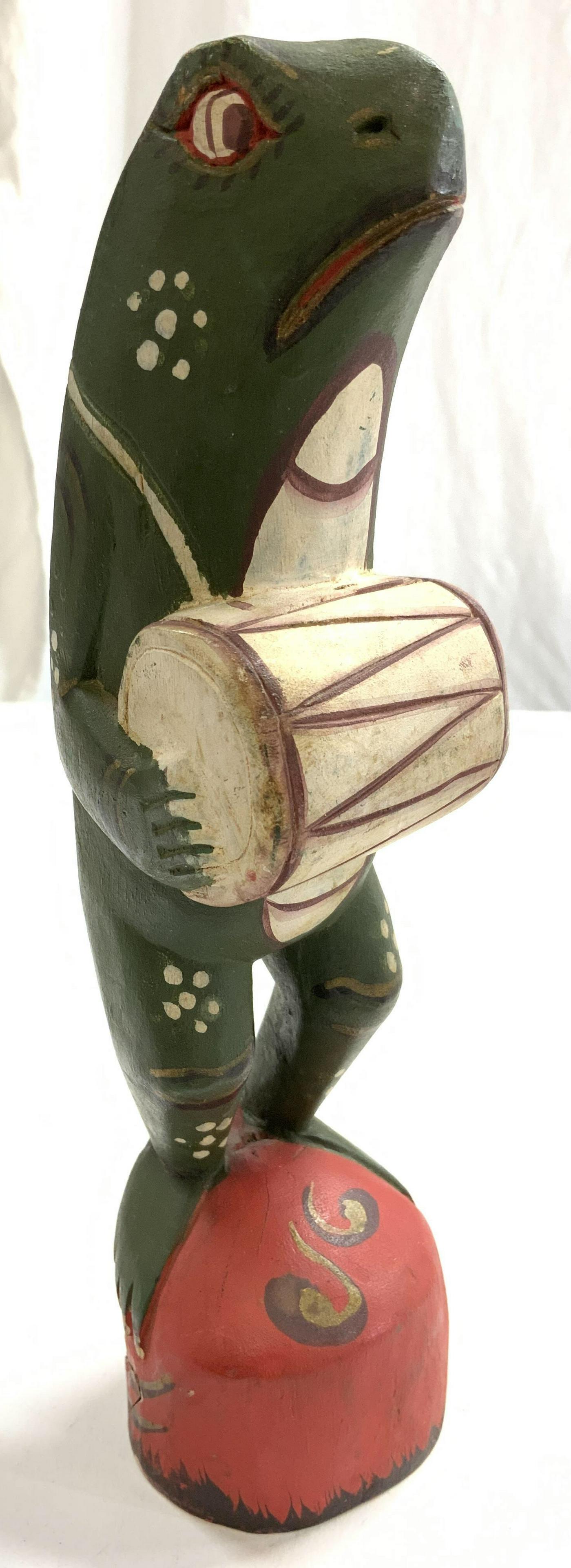 J MOSER Signed Wood Frog W Drum Figure: Underside is signed J MOSER. Piece is hand painted & wooden. Depicts a frog holding a drum. Measures approx 8.25 inches tall 2 inches wide 2.5 inches deep. Decorative arts, j moser sculpture, hand pai