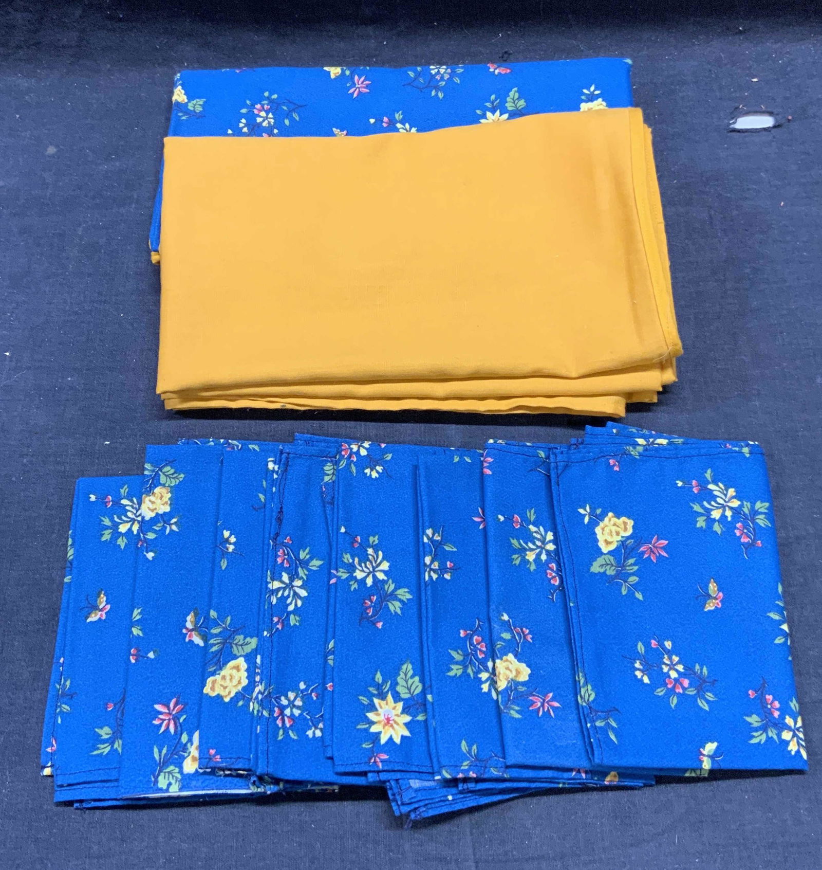 Lot 10 Yellow & Blue Tablecloths & Napkins: Lot of 10 pieces. Set includes 8 blue floral print napkins, material feels like cotton, sizes vary slightly approx. 13 x 10 inches each. 1 blue floral print tablecloth, material feels like cotton, mea