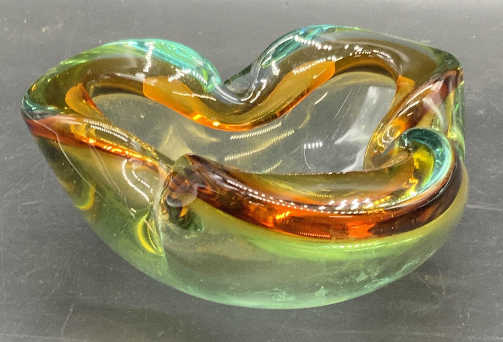 Vintage Murano Art Glass Sommerso Bowl: Vintage Murano style art glass sommerso bowl / ashtray. Pale amber and cyan hues. Thick walled. Some surface wear consistent with age and use. Measures approx 2.5H x 6W in. Sticker residue to undersid