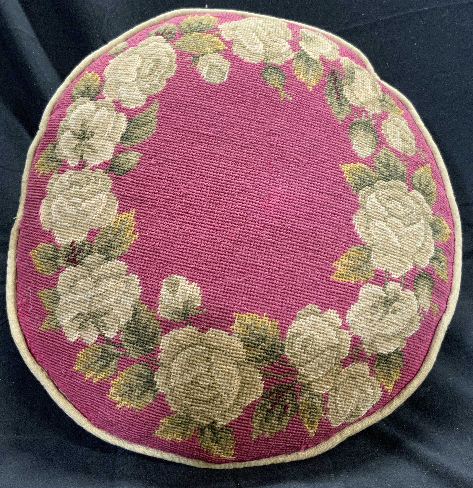 Vintage Circular Needlepoint Pillow W Floral Motif: Pillow is vintage possibly antique. Front side has needlepoint area with multi toned floral & leaf detail. Piece measures approx 13.5 inches diameter 5 inches deep. Pillow, needlepoint pillow, vintage