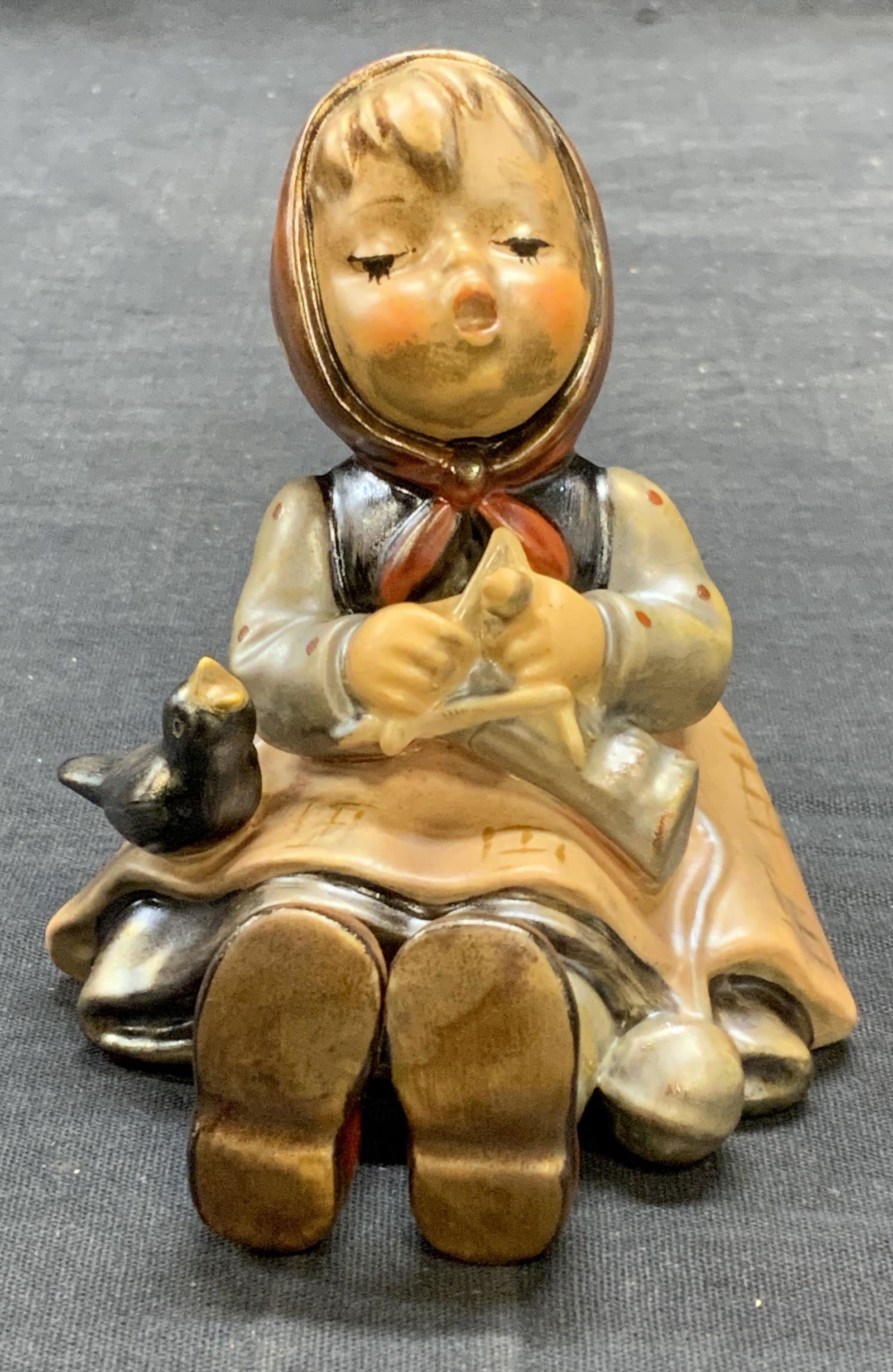 Vntg GOEBEL Hummel Porcelain Girl Figural WGermany: Vintage GOEBEL MJ Hummel porcelain figurine of a girl. Some surface wear including crazing observed. Trademarked to underside. Made in west Germany. Measures approx. 3 x 3 x 3.5 inches. Including Macy