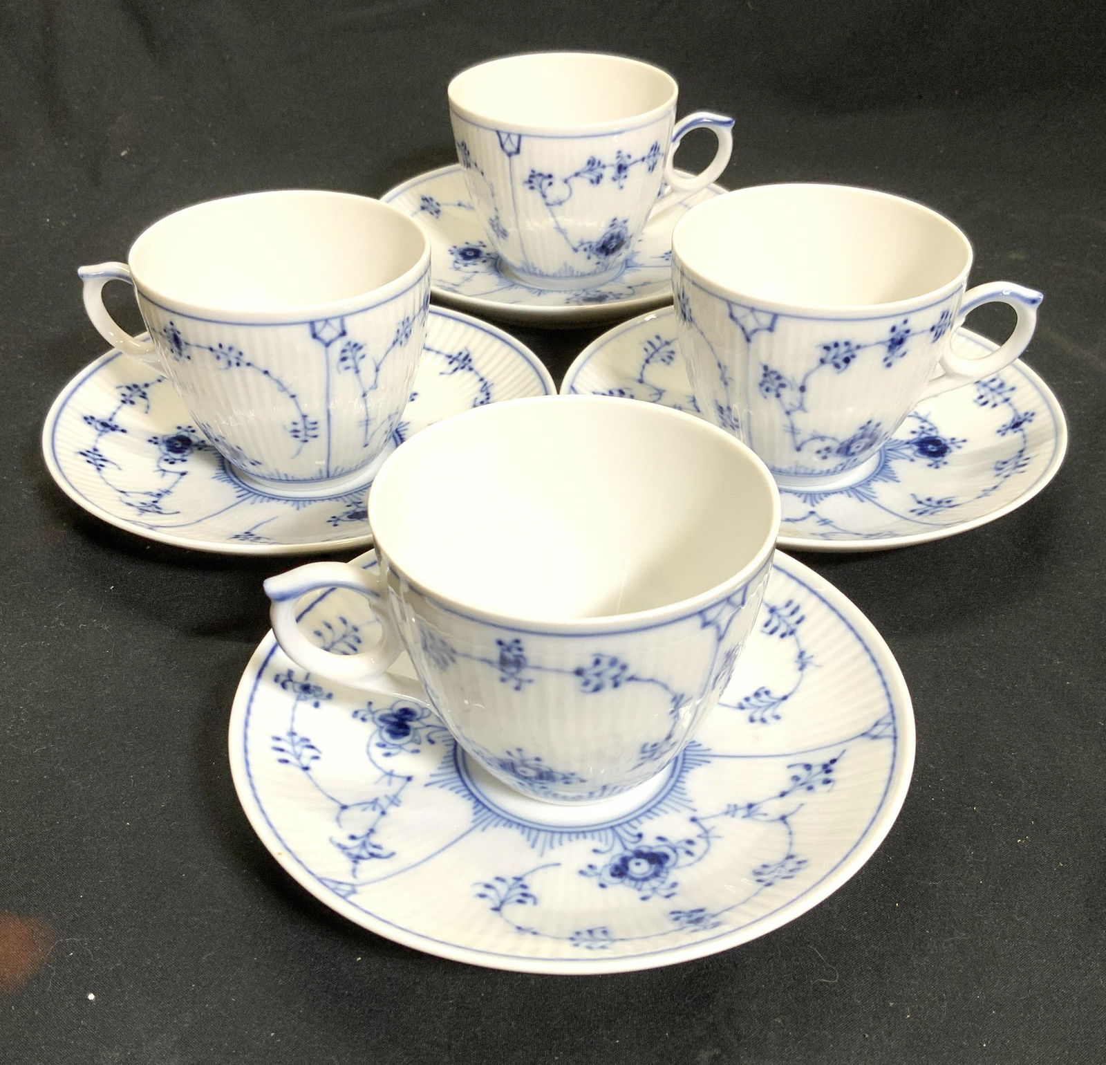 Royal Copenhagen Tea cup and Saucer Set 8, Denmark: Blue and White Royal Copenhagen Fine Bone China ware; pattern The classic Blue Fluted Plain. set of 4 teacup with set of 4 matching Saucers. Saucers measure 5.7/8 in. Diameter , cups measure 2.5 in ht
