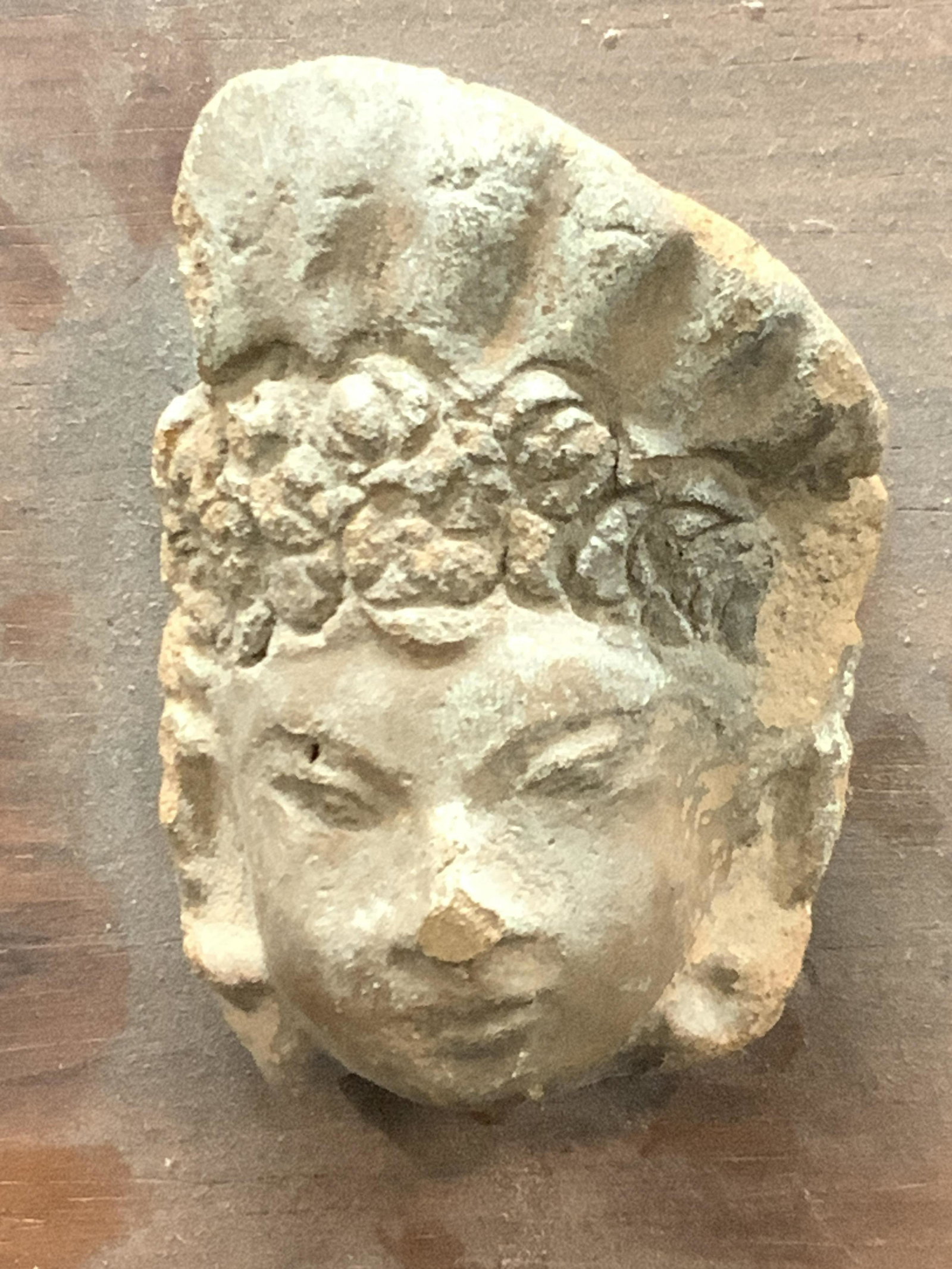 Mounted Vintage Asian Terracotta Head: Vintage terracotta clay head mounted to a slab of wood with Asians style ornamentation on head piece. Approximately 9.75 x 5.5 inches, head is approximately 3 inches tall. Moderate wearing due to ages