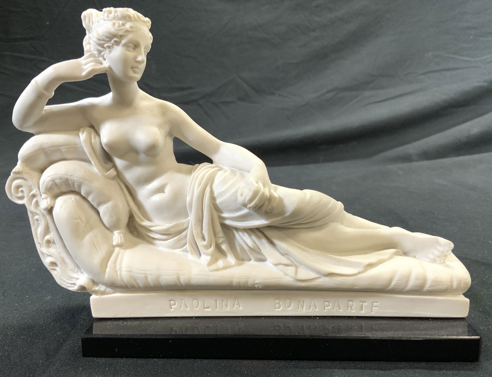 SANTINI PAOLINA BONAPARTE Alabaster Nude Sculpture: Tag on underside reads A SANTINI, base of sculpture reads PAOLINA BONAPARTE. Depicts a partial female nude figure laying on chaise. Piece is white toned alabaster with black toned base. Sculpture meas