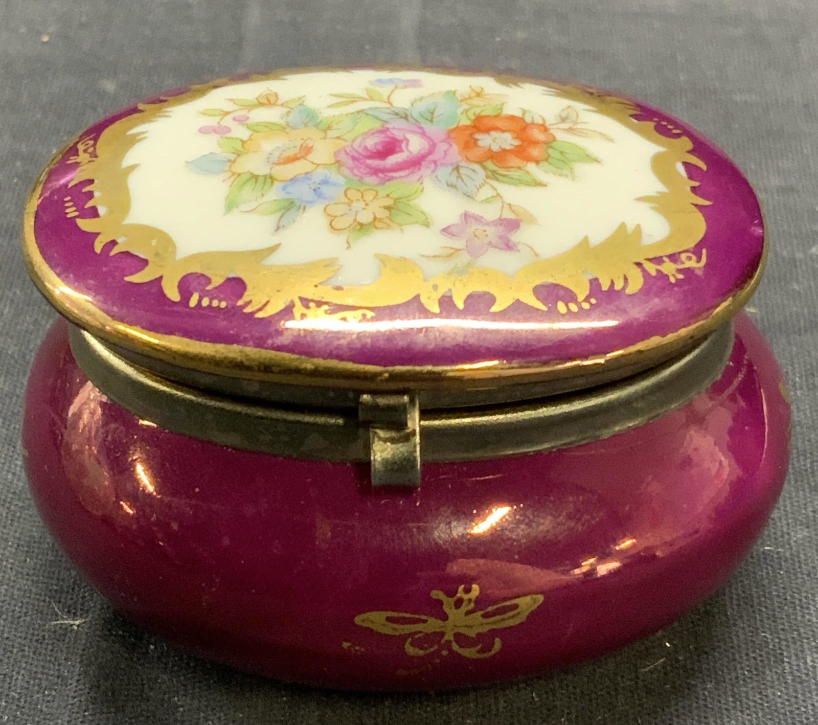 Vintage KPM Porcelain Floral Trinket Box: Vintage KPM porcelain trinket bow in burgundy with gilt decoration and floral motif. Trademarked to underside. Measures approx. 2.5 x 2 x 1.5 inches. Some surface wear consistent with exposure. KPM, K