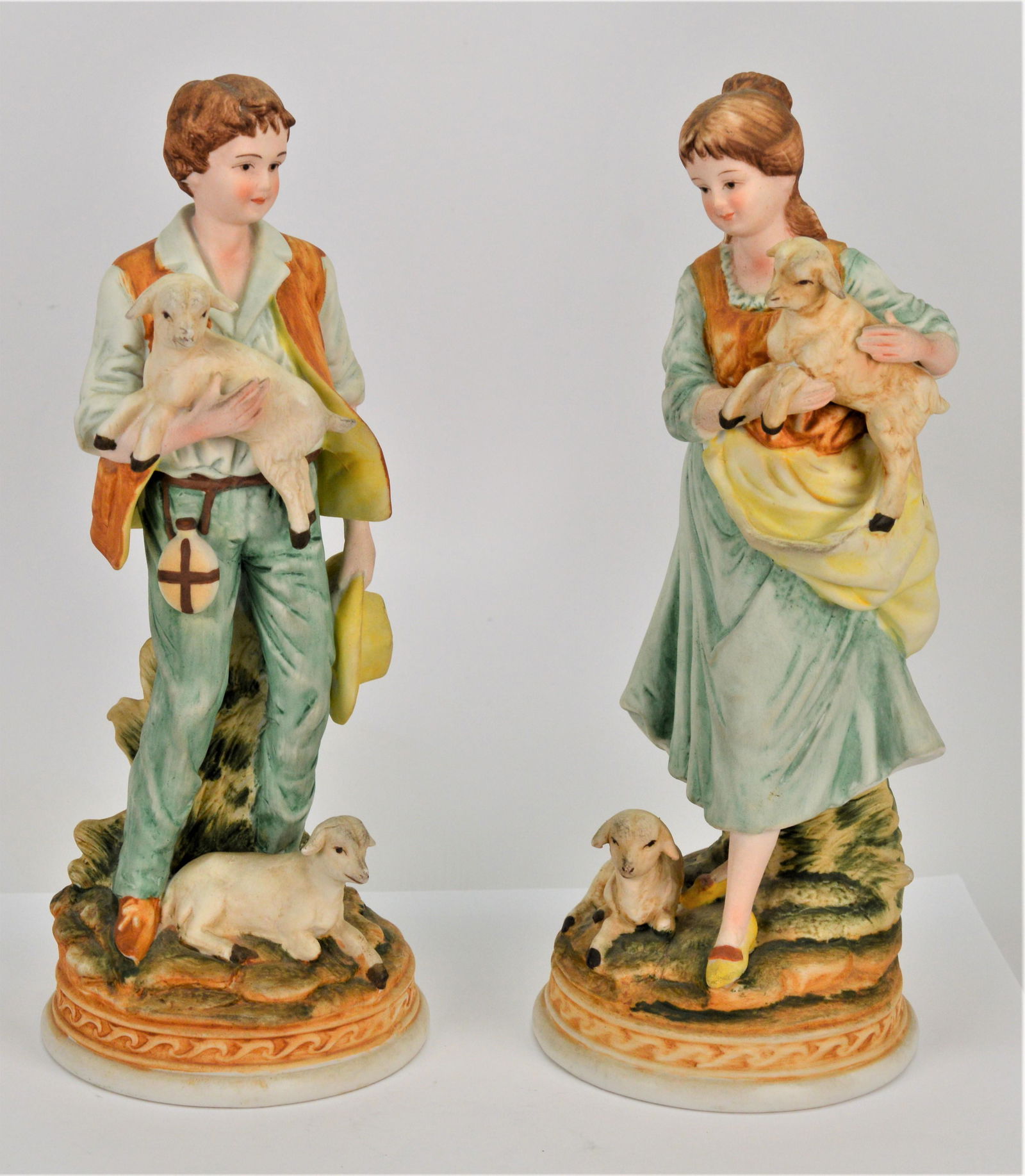 ETHAN ALLEN Man and Woman Porcelain Figurines: Vintage Ethan Allen Porcelain Figurines. Man and woman with sheep. They stand 9" tall and the base is 3.5". There is no visible damage. Signed and numbered. -NB 28