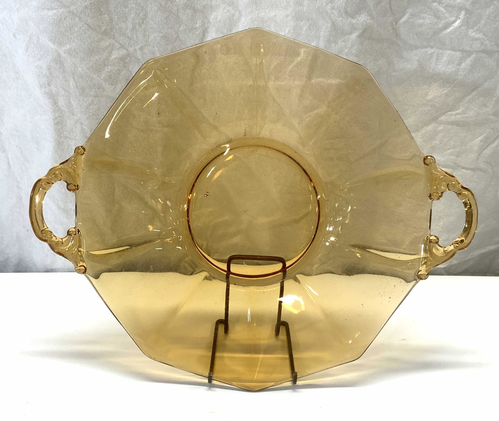 Amber Toned Pressed Glass Platter: Amber toned pressed glass platter. Surface wear consistent with exposure. Measures approx. 14 x 11.5 inches. Glass platter, glass tray, amber glass platter, amber glass tray, serving platter, Servewar