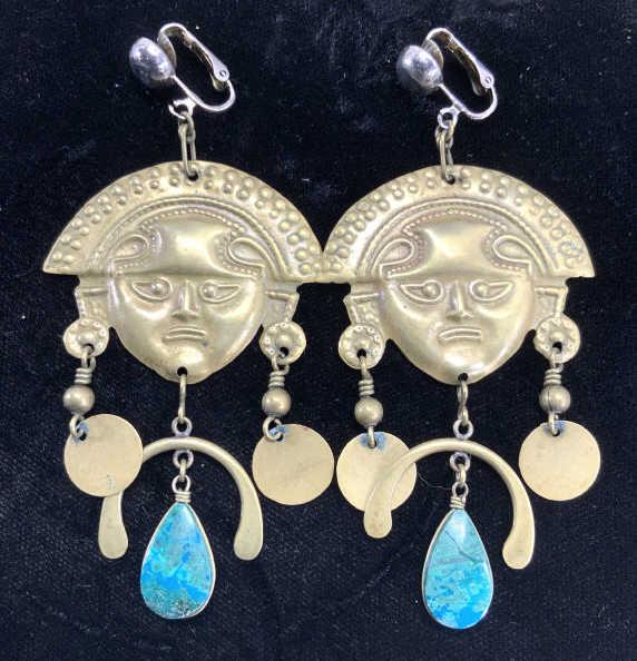 Repousse Brass Incan Sun God Clip On Earrings: I can Sun God earrings made of brass metal with dangling pendants and natural gemstone , possibly amazonite. Measures 3.5 in. L x 1.7 in. W clip on style but can be changed into pierced earrings. Ligh