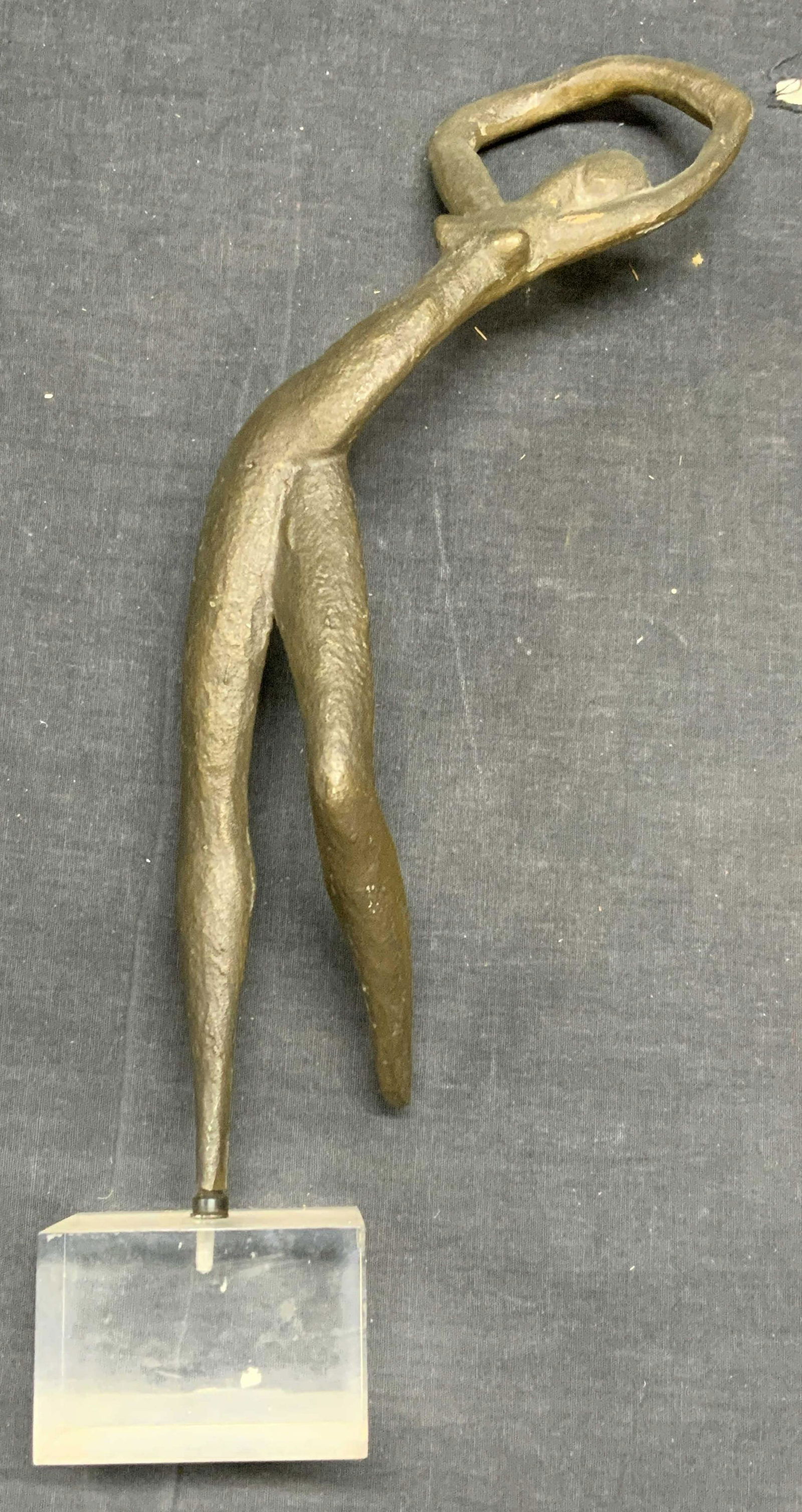 Bronze Nude Woman Figural Sculpture: Bronze nude figural sculpture of a woman on lucite base. Needs adjustment to base. Some surface wear consistent with exposure. Total dimensions approx. 7.25 x 3 x 15.5 inches. Piece has weight. Art, a