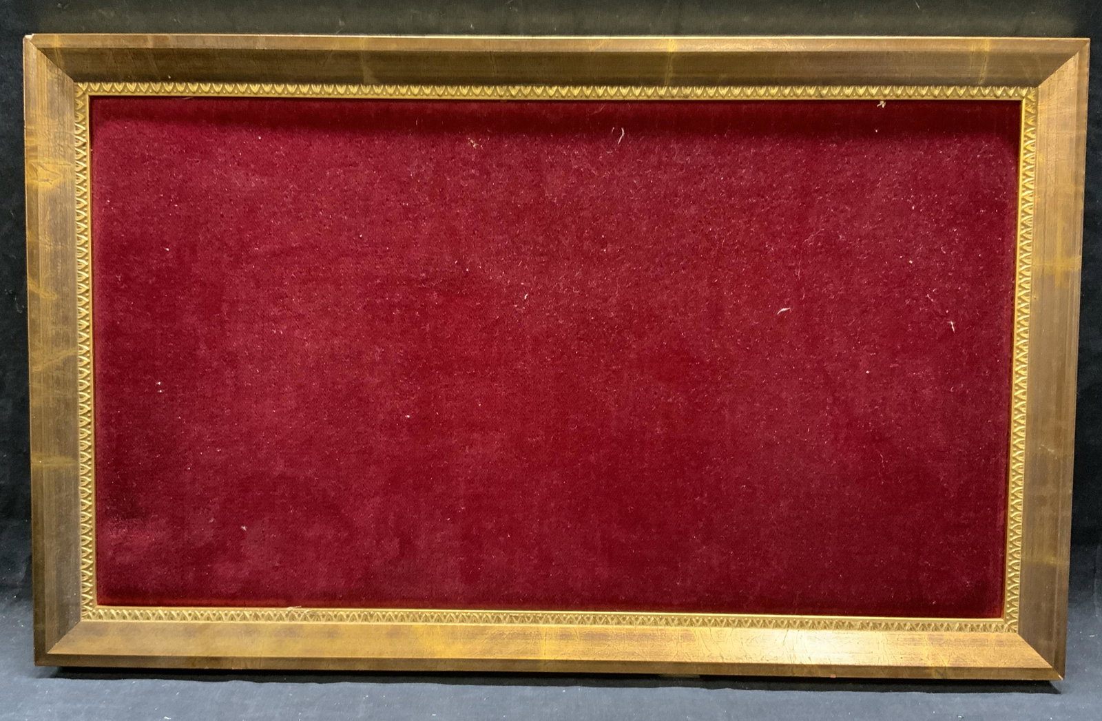 Gilt Wood Hanging Wall Frame: Gilt wood hanging wall frame with red velour backing. Some surface wear consistent with exposure. Measures approx. 12.25 x 20.25 inches. Window approx. 10.25 x 18.25 inches. Frame, gilt wood frame, wa