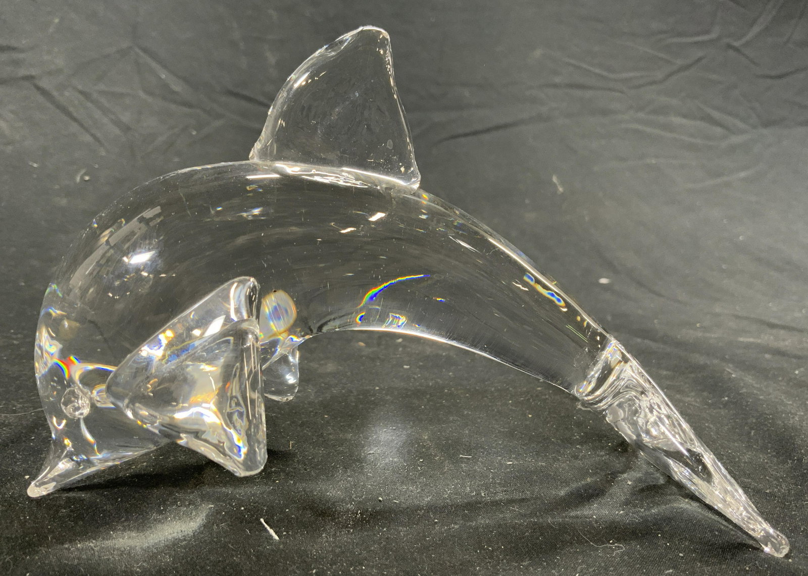 Art Glass Dolphin Figure: Dolphin figure is glass. Depicts a dolphin with arched back. Piece measures approx 6 inches long 4.25 inches tall 2.75 inches wide. Dolphin, Dolphin Figure, glass dolphin, art glass, Art glass dolphin
