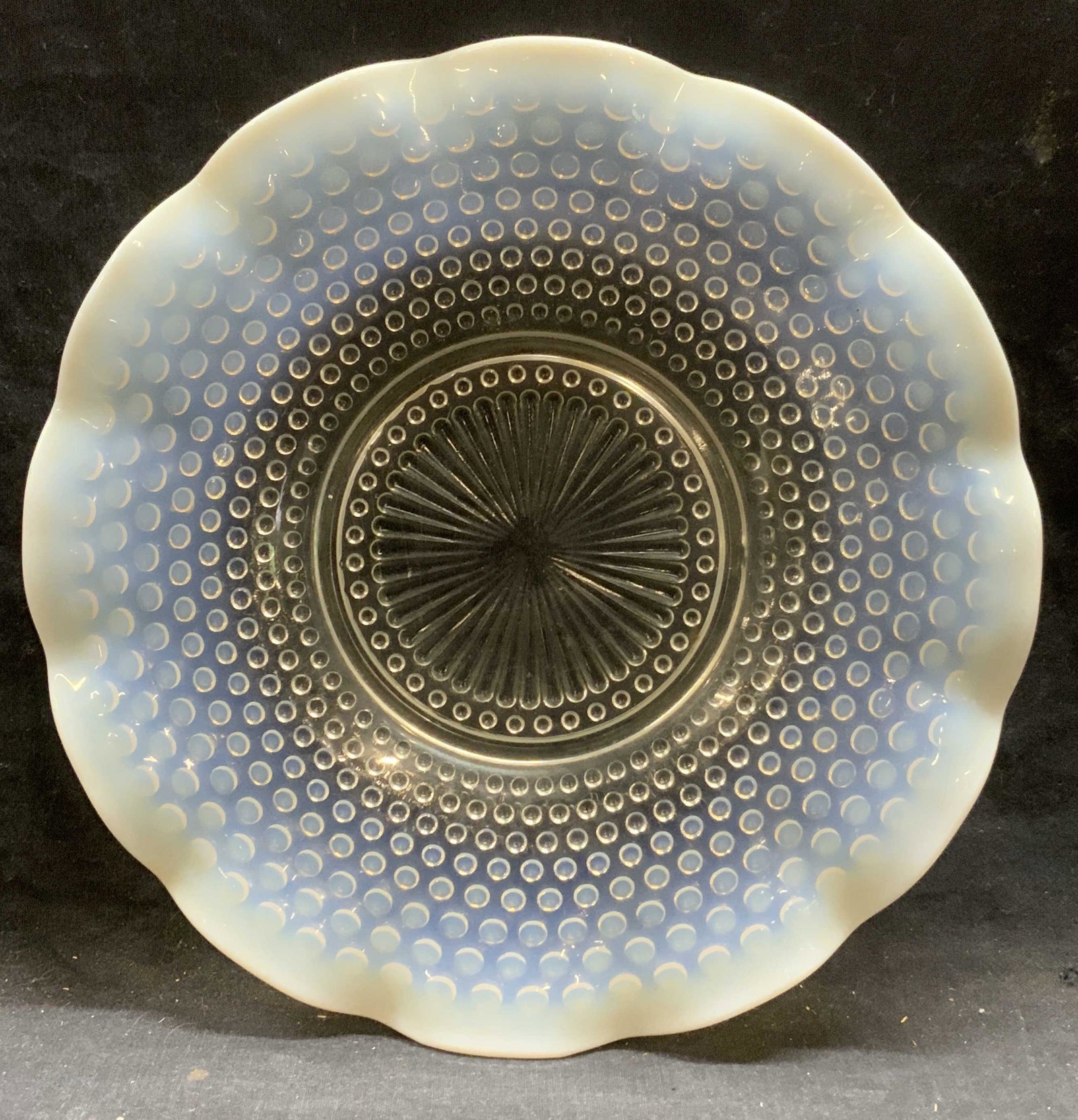 Opaline Hobnail Art Glass Dish: Opaline and transparent hobnail art glass dish with handkerchief rim. Some surface wear consistent with exposure. Measures approx. 10.75 inches diameter. Art glass, studio glass, hobnail glass Opaline