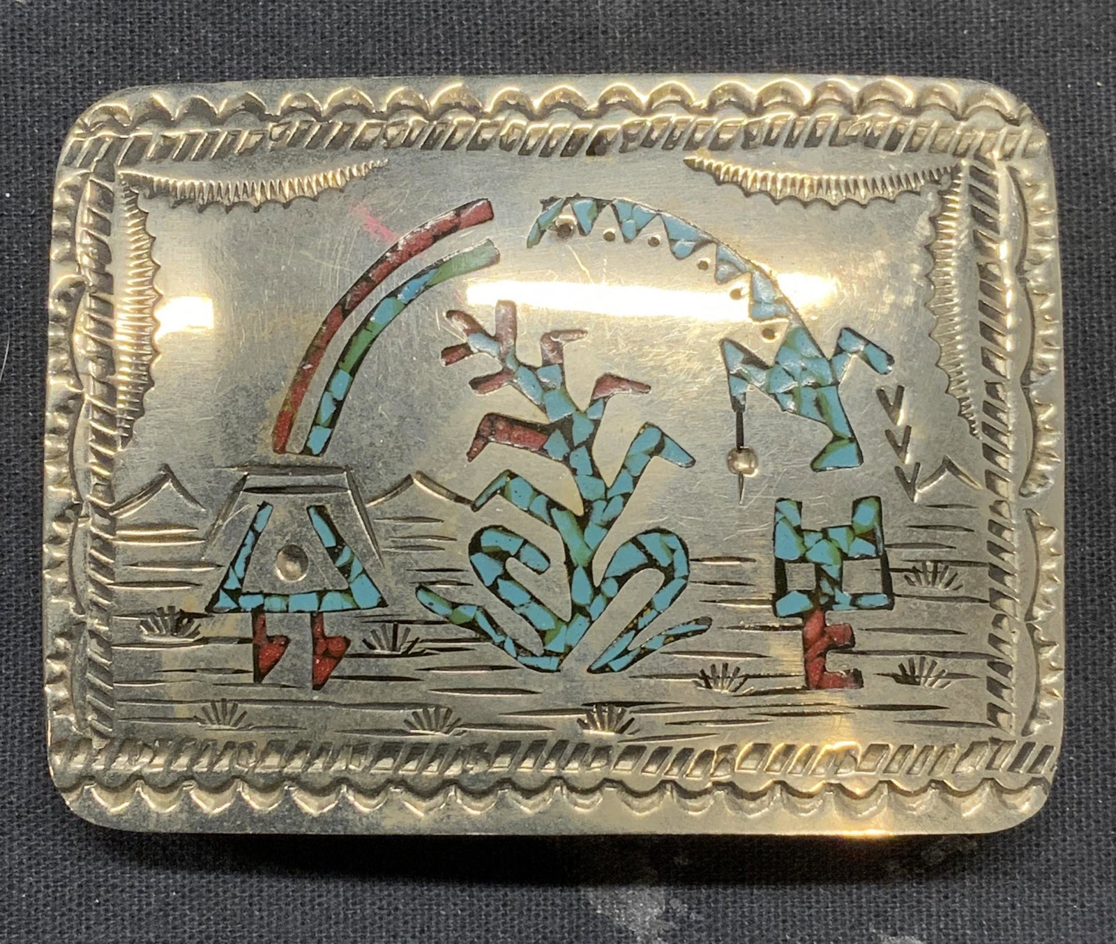 Silver Tone Etched Stone Mosaic Belt Buckle: Silver tone etched metal belt buckle with blue and red stone mosaic decoration. Marked W to underside. Measures approx. 2.75 x 2 inches. Some surface wear consistent with exposure. Belt buckle. Silver