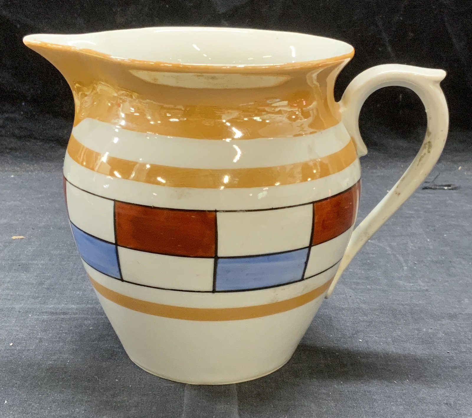 Antq Art Deco UNION K Porcelain Lustreware Pitcher: Antique circa 1920s Art Deco Union K porcelain lustreware pitcher with geometric pattern. Trademarked to underside. Measures approx. 7.5 x 5.5 x 5.75 inches. Some surface wear consistent with exposure