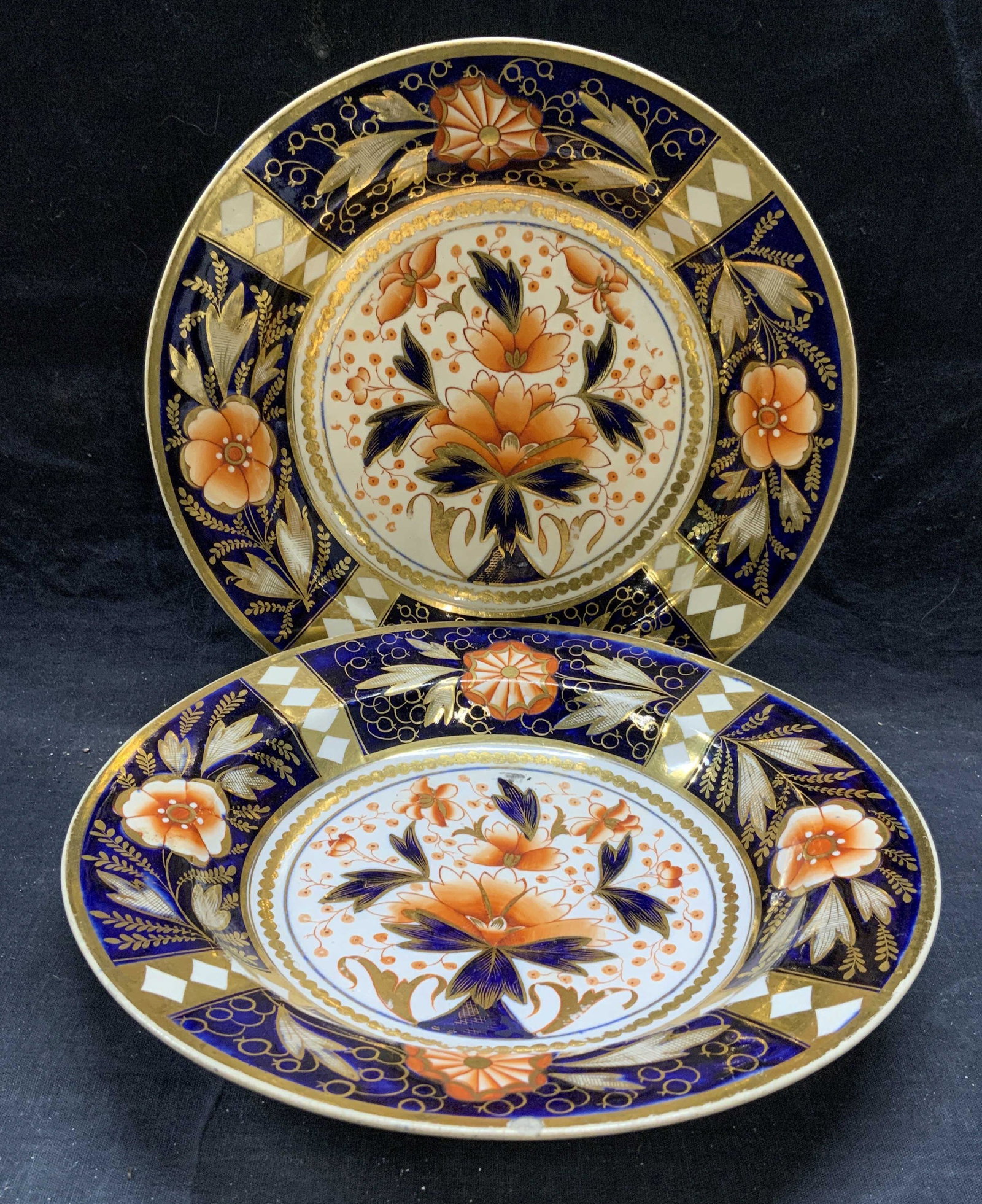 Pair Vintage Imari Porcelain Bowls: Pair of vintage, possibly antique, porcelain bowl with Imari pattern. Orange and blue with gilt decoration and floral motif. Measure approx. 9 5/8 inches diameter and 1.75 inches tall. Some surface we