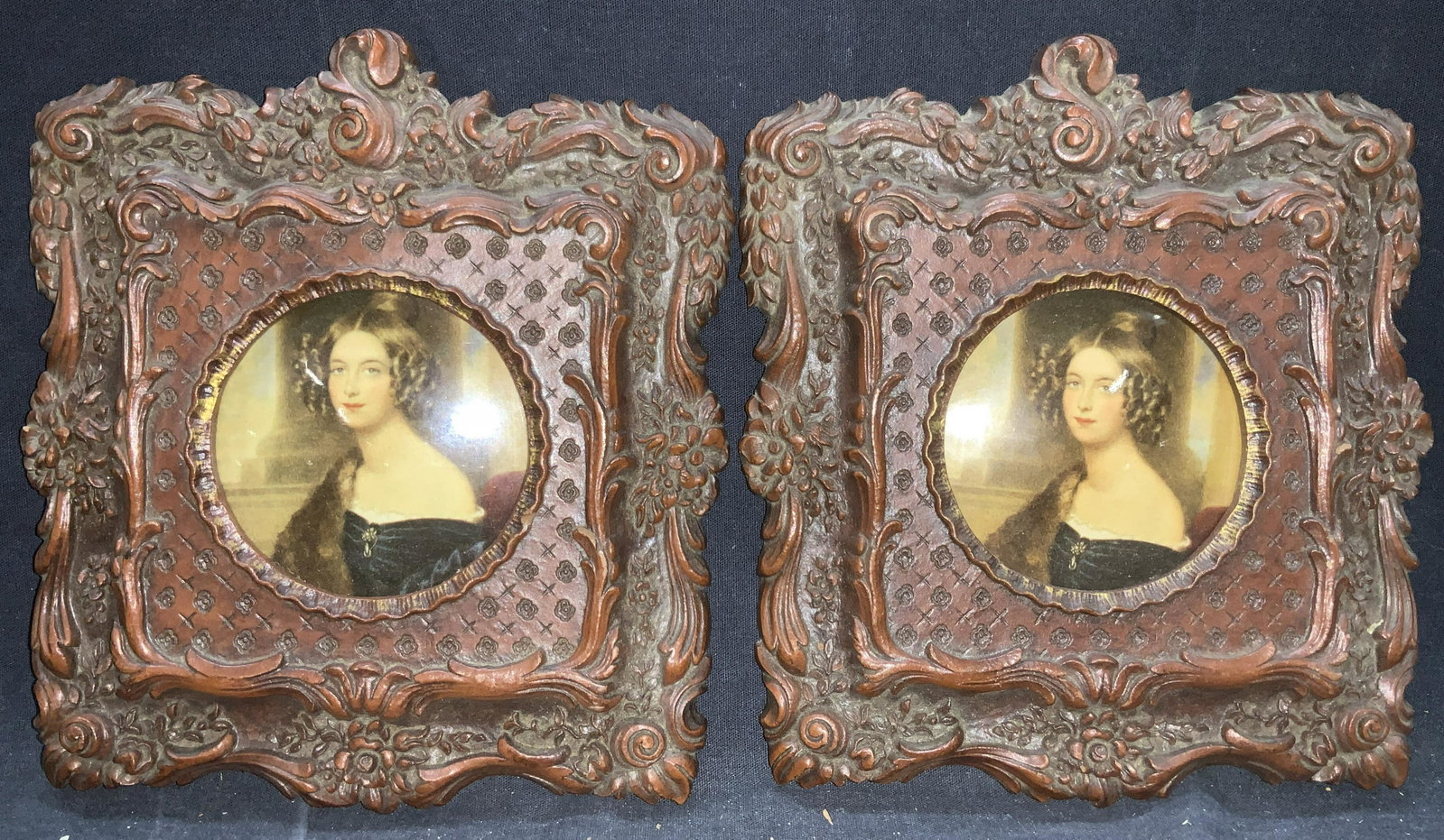 Pair SYROCO WOOD USA Framed Portraits: Pair of SYROCO WOOD composite framed portraits. Depicting the same blonde haired woman in a black dress with a fur over her shoulder. Frame is ornate with scrolls on the edges and floral motifs throug