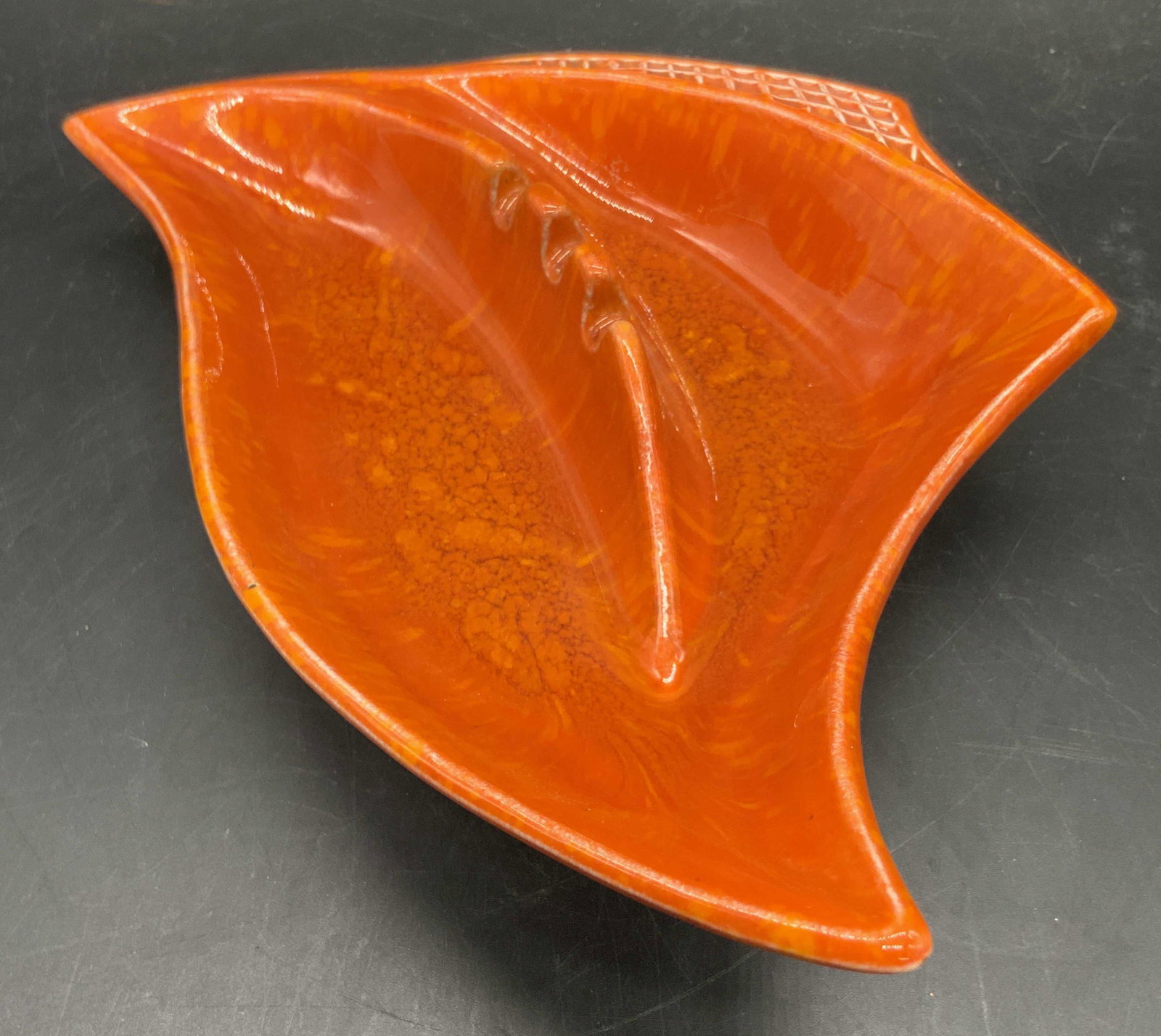 CALIFORNIA USA Vtg Orange Abstract Ceramic Ashtray: A glazed orange abstract angular form ceramic ashtray / trinket dis. Orange lava style glaze throughout. Etched detailing to the side. Divots for placing cigarettes to the center. Underside signed CAL
