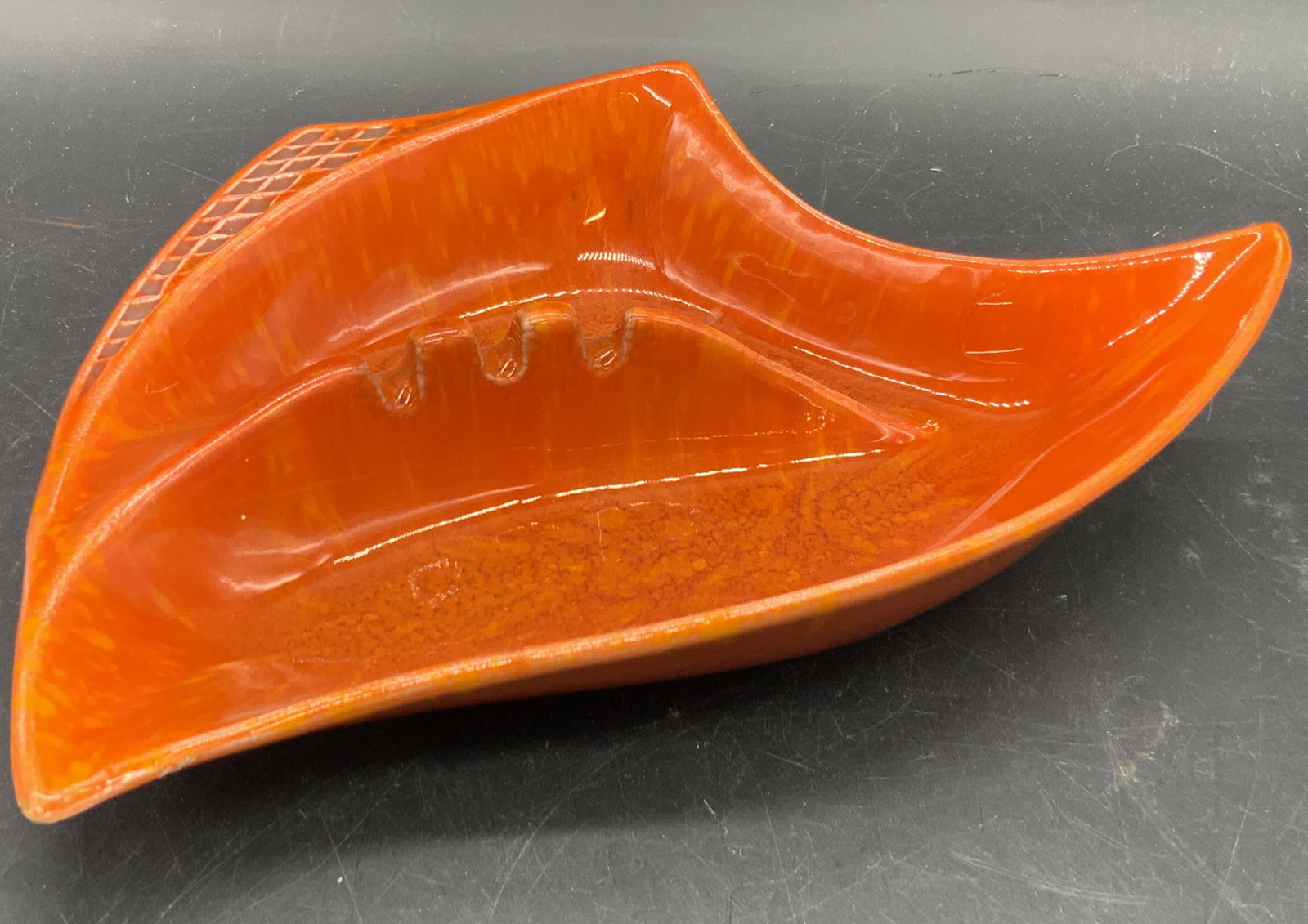 CALIFORNIA USA Vtg Orange Abstract Ceramic Ashtray: A glazed orange abstract angular form ceramic ashtray / trinket dis. Orange lava style glaze throughout. Etched detailing to the side. Divots for placing cigarettes to the center. Underside signed CAL