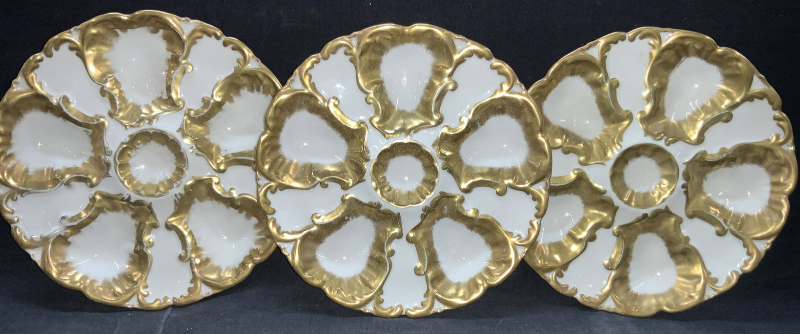Set3 LS & S Limoges Porcelain Oyster Dishes France: Set of 3 white porcelain oyster dishes with gilt centers and outer rims. All marked on undersides Ls & S Limoges, France. Approximately 8.5 inch diameter. Moderate wearing to gilt on dishes. Limoges p