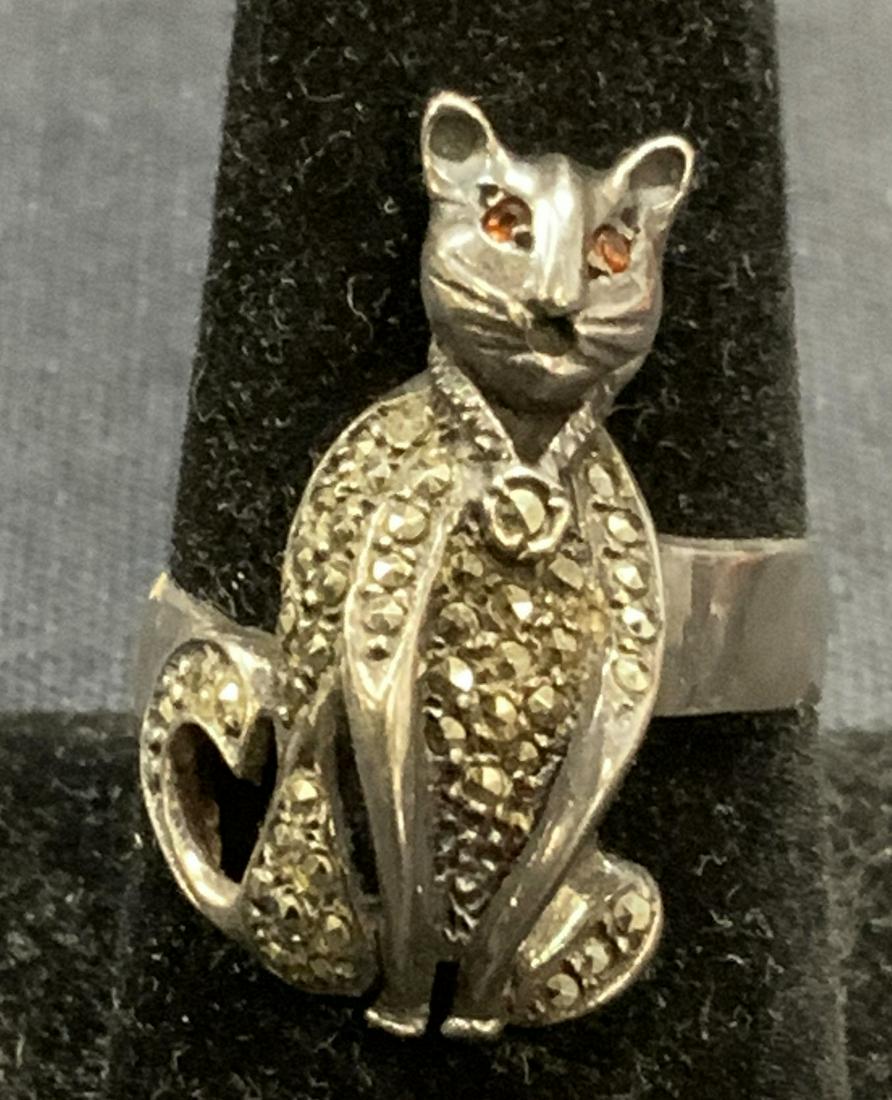 Sterling Silver & Marcasite Cat Cocktail Ring: Sterling silver and marcasite cat cocktail ring. Size 8. Cat measures approx. 7/8 x 5/8 inches. Some surface wear consistent with exposure. Total weight .20 ozt. Tests for sterling using PuriTEST kit.