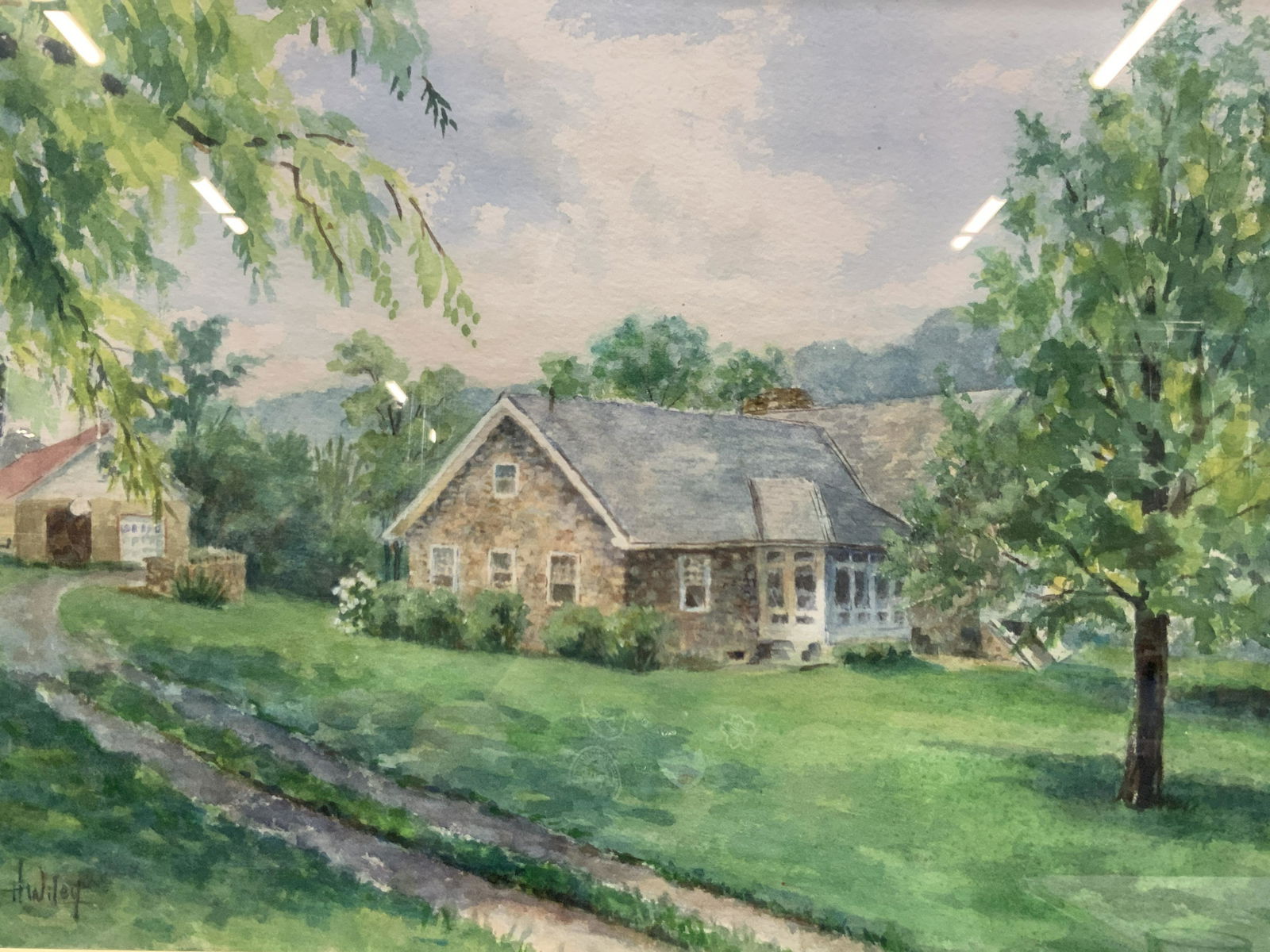 H.Wiley Signed Watercolor House Painting: Signed on lower right corner H.Wiley Depicts a house and garage in the background. Framed in wooden frame with gold outer edge with off white linen mat board. Approximately 18.75 x 26inches window mea