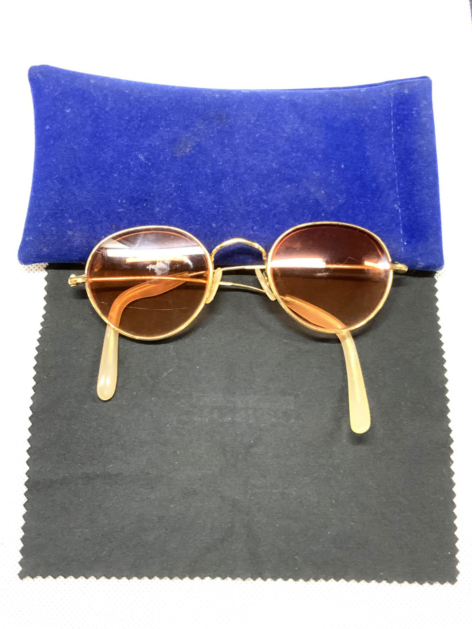 Vintage Aloha 14 Kt Ro Spectacles W Case, England: Marked on arm Aloha 14 Kt Ro, made in England. With amber toned lens, approximately 1.75 x 1.75 inches wide. Comes with blue eye glass case with black cleaner cloth. Arms of frames are slightly warped