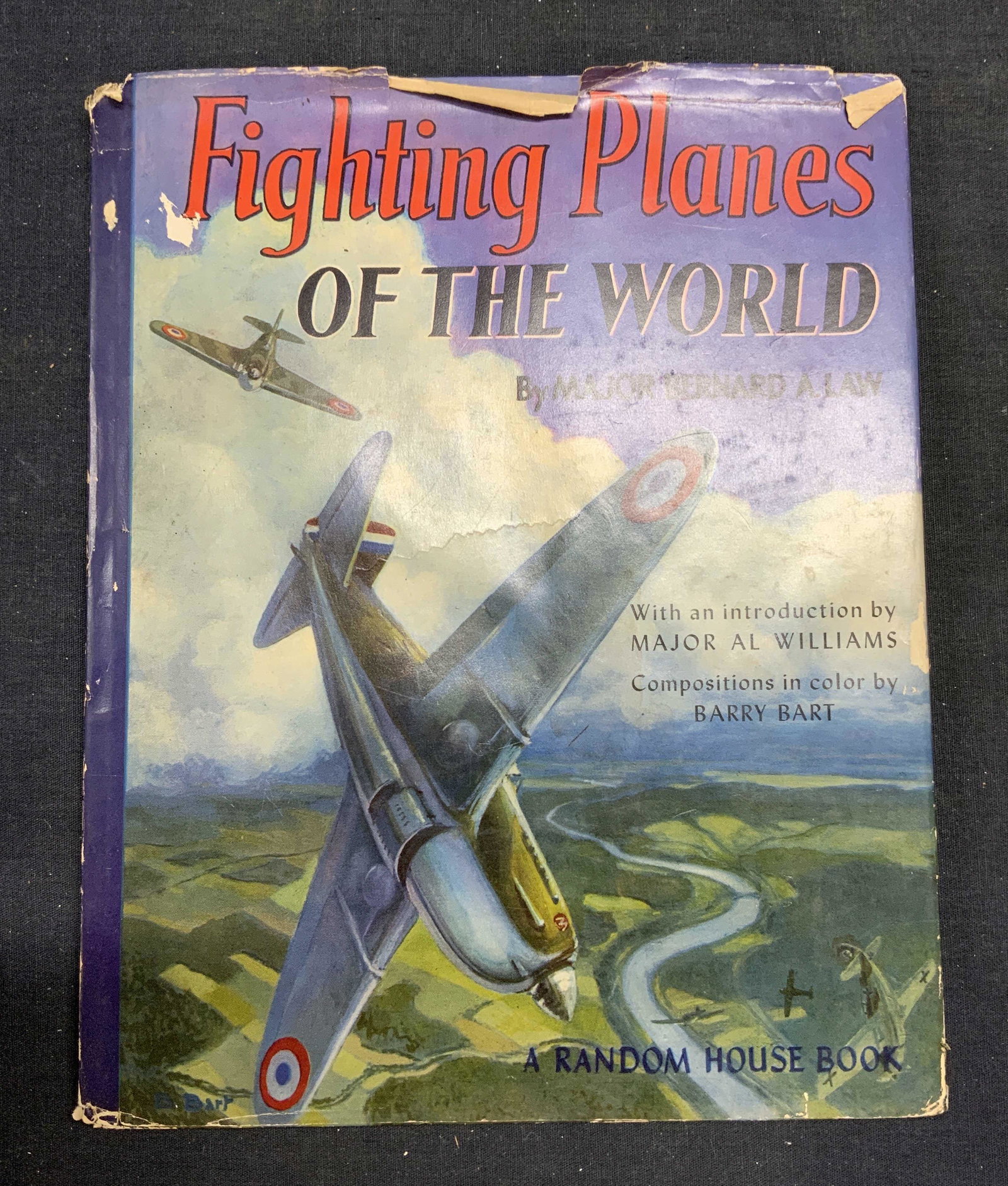 1941 Fighting Planes of the World, Illustrated: Hardbound copy of Fighting Planes of the World by Major Bernard A. Law. Illustrated by Barry Bart. Published by Random House, 1941. General shelf wear to dust jacket, cover, pages, and spine consisten