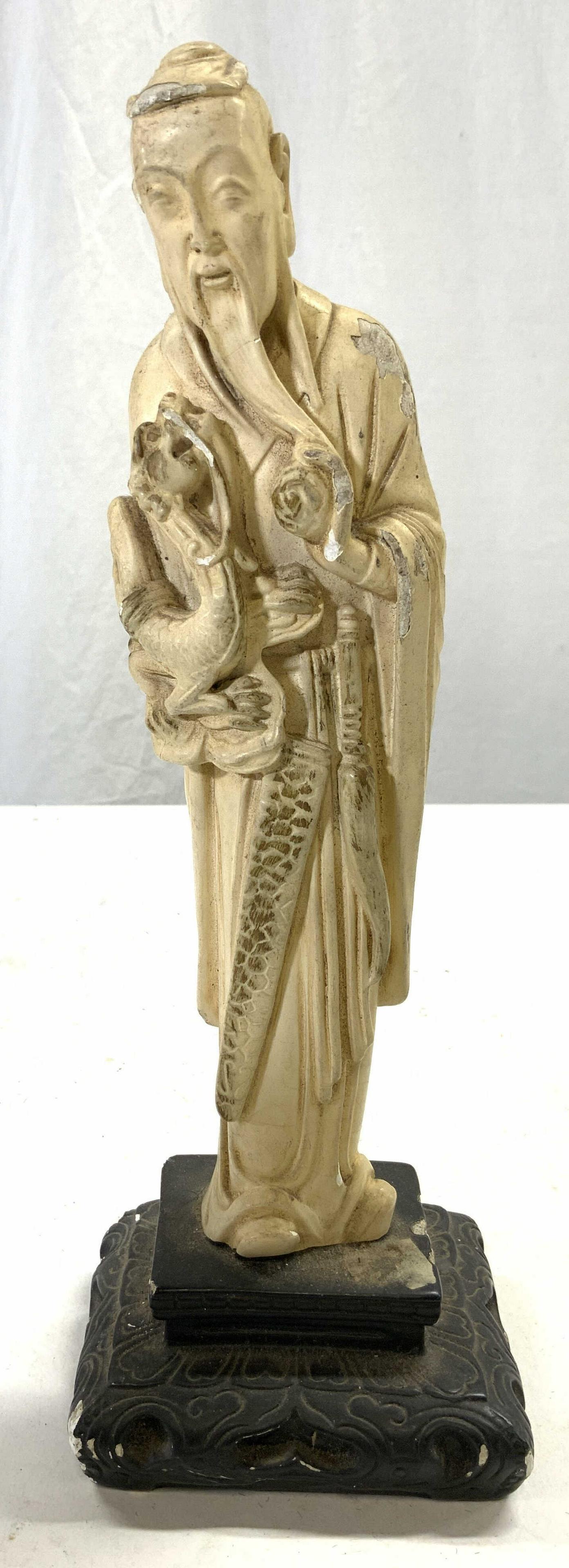 COLUMBIA STATUARY Vintage Asian Plaster Figural: Tag on underside reads COLUMBIA STATUARY made in Italy. Male figure is vintage. Piece is cream toned with black base. Sculpture Depicts an elderly wise man figure holding a dragon. Piece measures appr