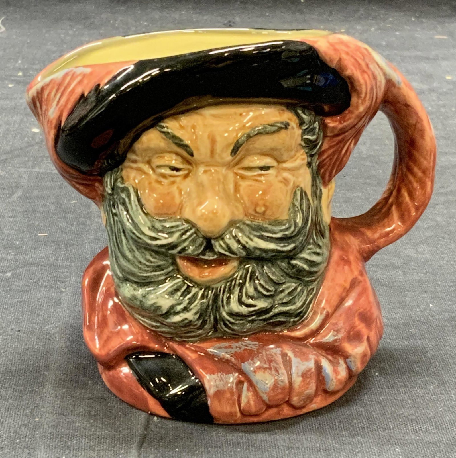 Royal DOULTON Ceramic Falstaff Toby Jug England: Vintage Royal DOULTON ceramic Sir John Falstaff Toby jug/creamer. Some surface wear consistent with exposure, trademarked to underside. Made in England. Measures approx. 4.25 x 3 x 3.5 inches. Royal D