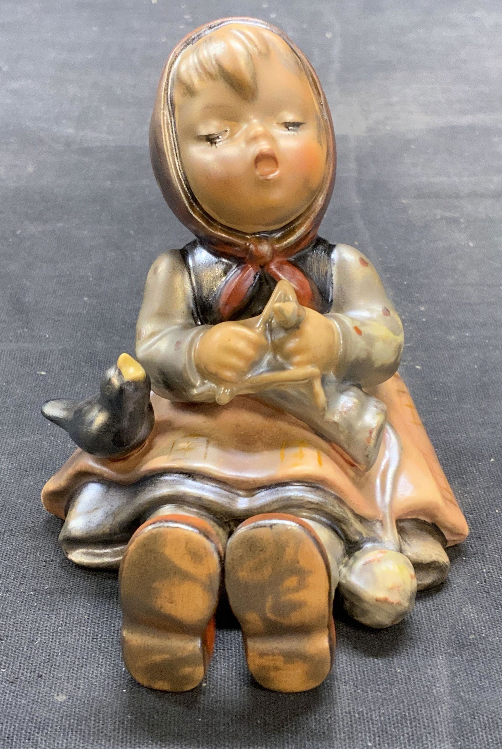 Vintage GOEBEL Hummel Porcelain Figurine W Germany: Vintage GOEBEL MJ Hummel porcelain figurine of a girl. Trademarked to underside. Some surface wear consistent with exposure. Measures approx. 3 x 3.25 x 3.5 inches. Includes Macys box. Made in West Ge