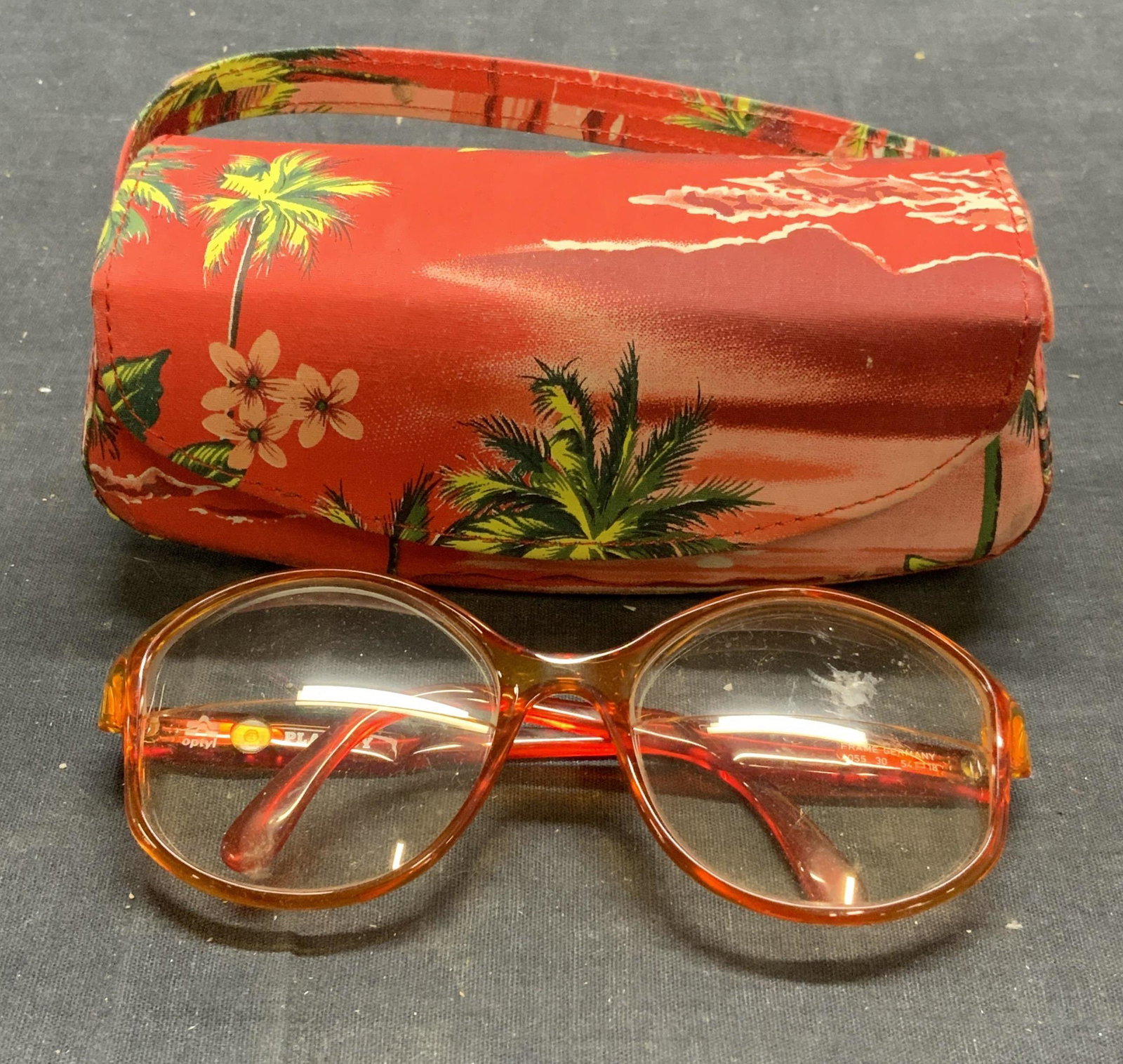 Optyl Playboy Orange Frame Sunglasses: Optyl Playboy orange acrylic frame sunglasses. Includes case. Designer label on arm. Some surface wear consistent with exposure. Measure approx. 5 x 5.5 x 2 1/8 inches. Optyl playboy, Optyl playboy su