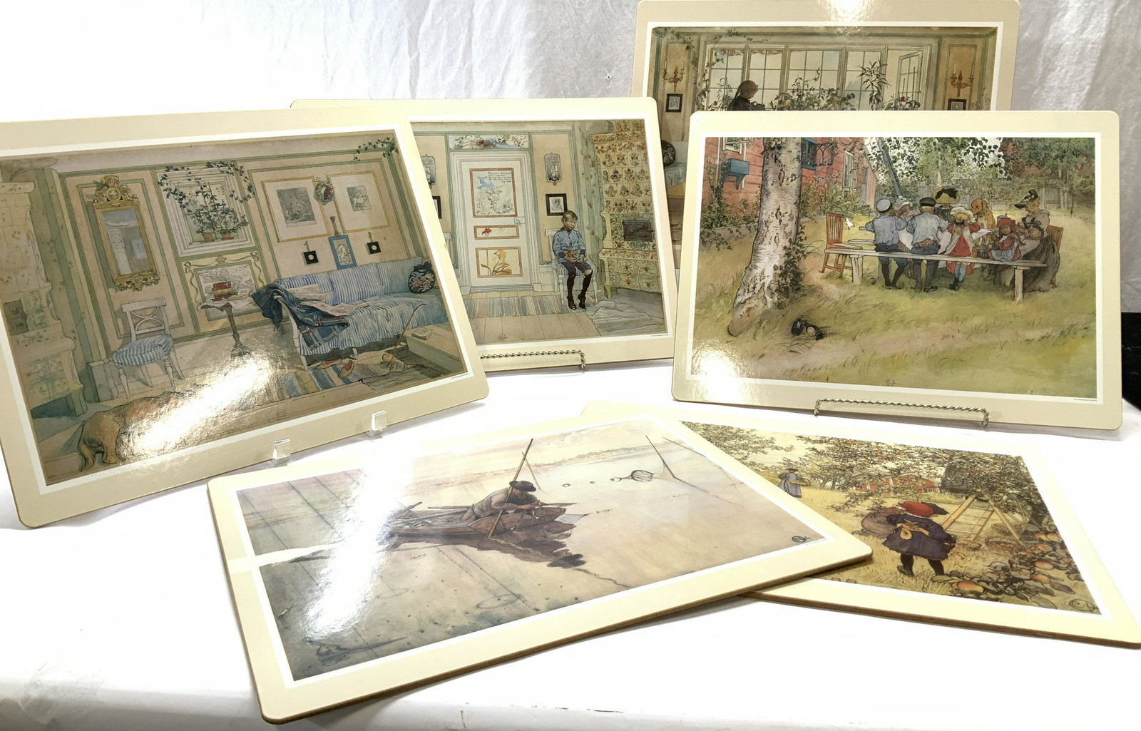 Set 6 Carl Larsson Laminated Cork Place mats: Various 19th century reproduction art by Carl Larsson on laminated paper and cork placemats. These are distributed by the National Museum of Stockholm ( corner right). Measures 15.75 x 11.75 in. . App