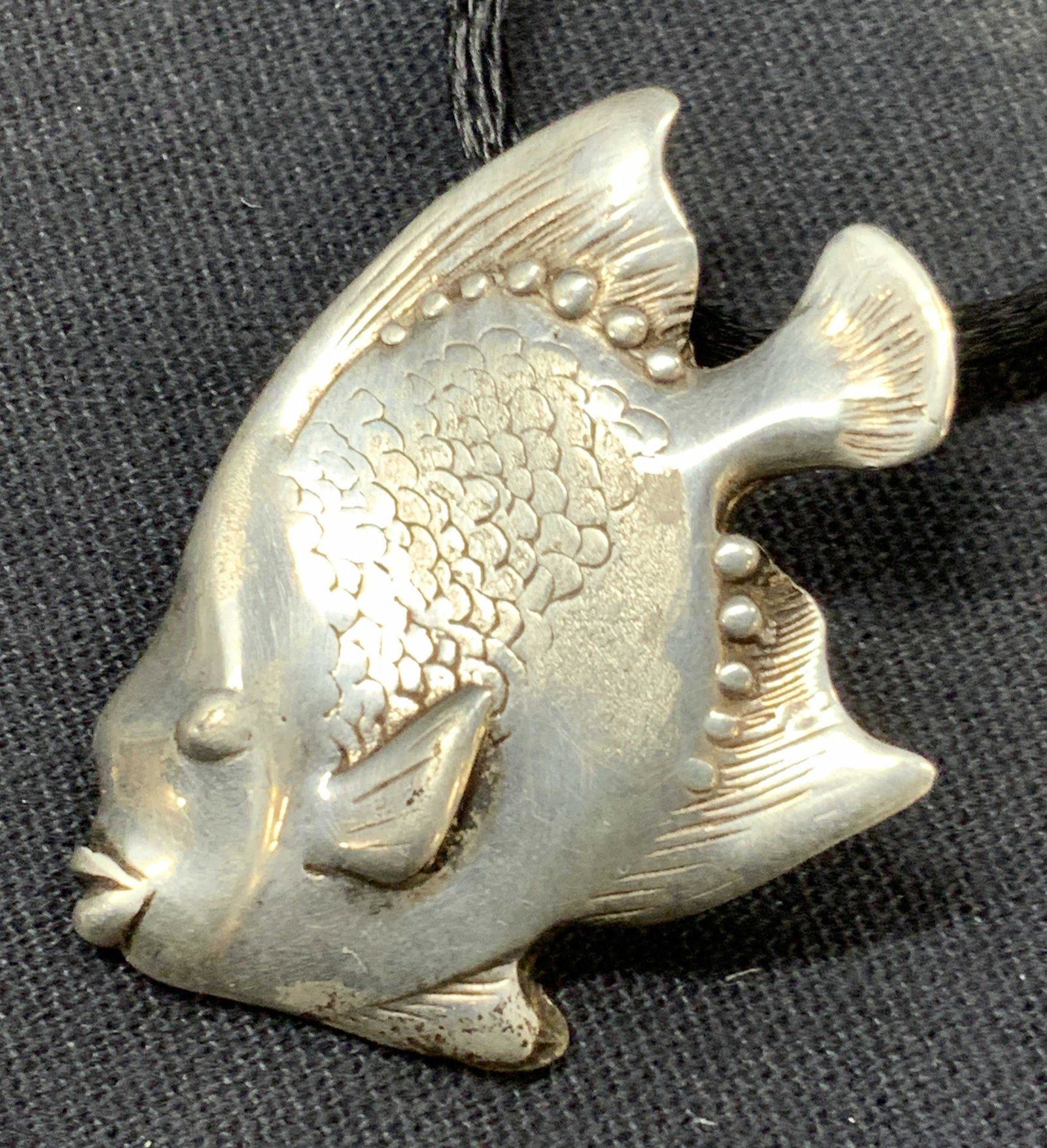 Sterling Fish Pendant Necklace: Sterling silver pendant necklace with black felt rope and fish pendant, marked 925 on clasps and pendant tested positive for sterling silver using Puritest metal tester Approximately 9.75 inches long.