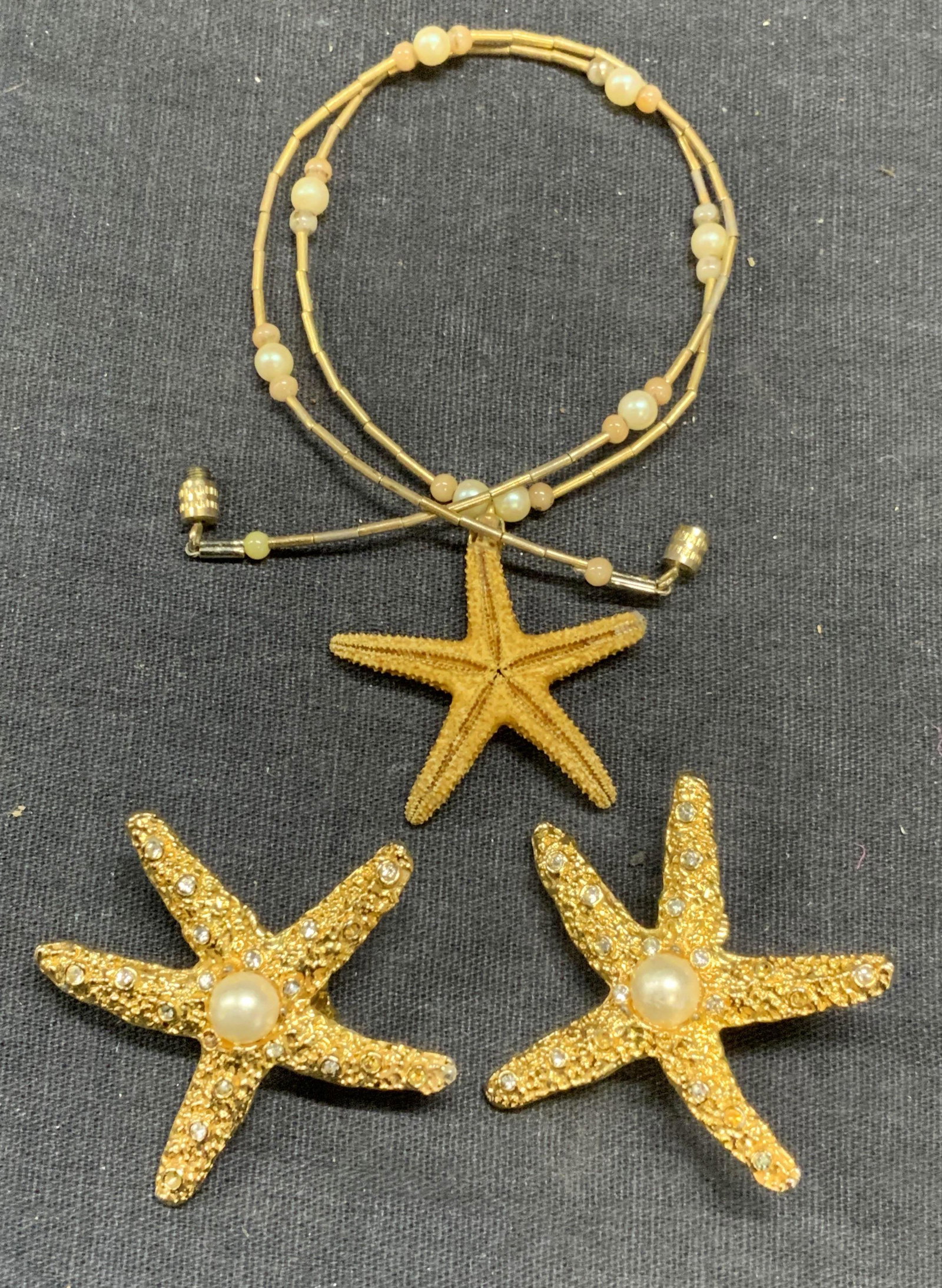 Lot 2 Kenneth Lane Gold Tn Starfish Earrings, More: Kenneth Lane gold tone starfish clip on earrings with faux pearl and crystal decoration. Designer label to backings. Measure approx. 1.5 inches diameter. Gold tone starfish pendant necklace with faux 