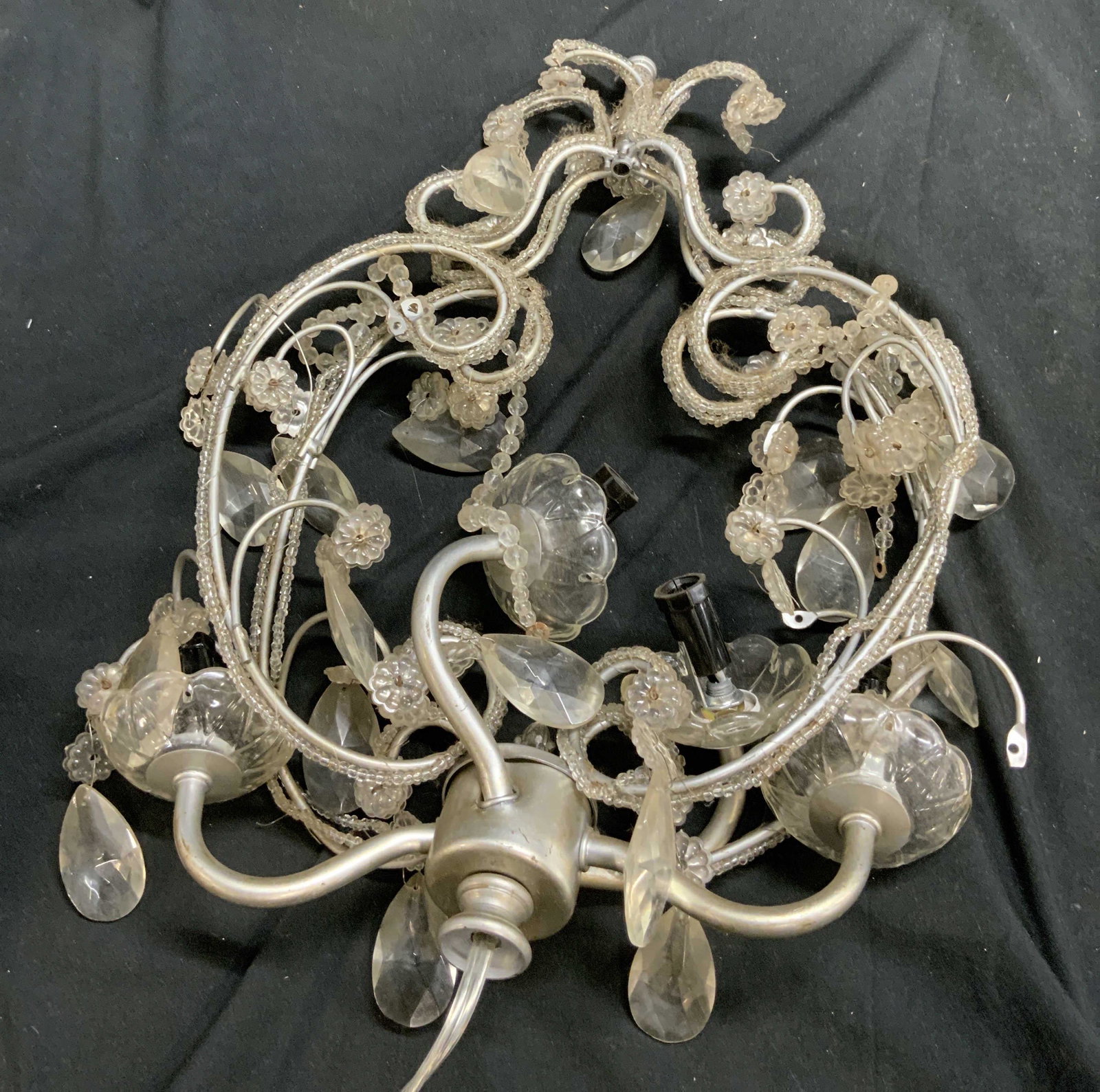 Vintage Beaded Metal 4 Arm Chandelier: Chandelier is vintage, silver toned and metal. Piece has beaded detail along structure. Chandelier has 4 arms. Piece measures approx 15.5 inches tall 13 inches wide. Chandelier, lighting, beaded chand