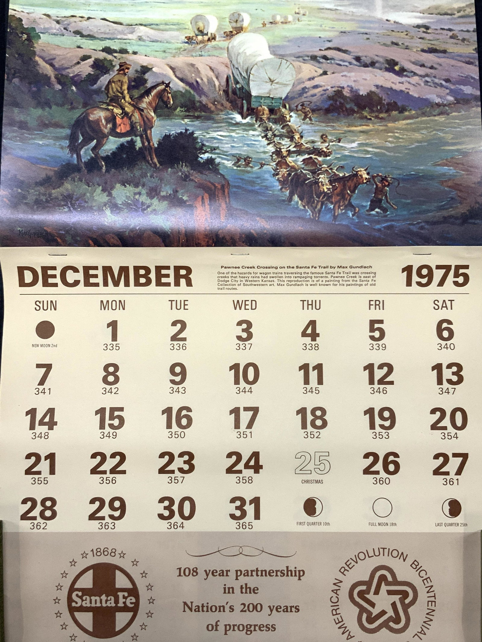 Sante Fe 1976 Bicentennial Calendar: Sante Fe American Revolution Bicentennial 1776-1976 Calendar. Never used. Art depicts a lithograph from Max Gundlach displaying pioneers in horse drawn carriages. Approximately 24.5 x14 inches Moderat