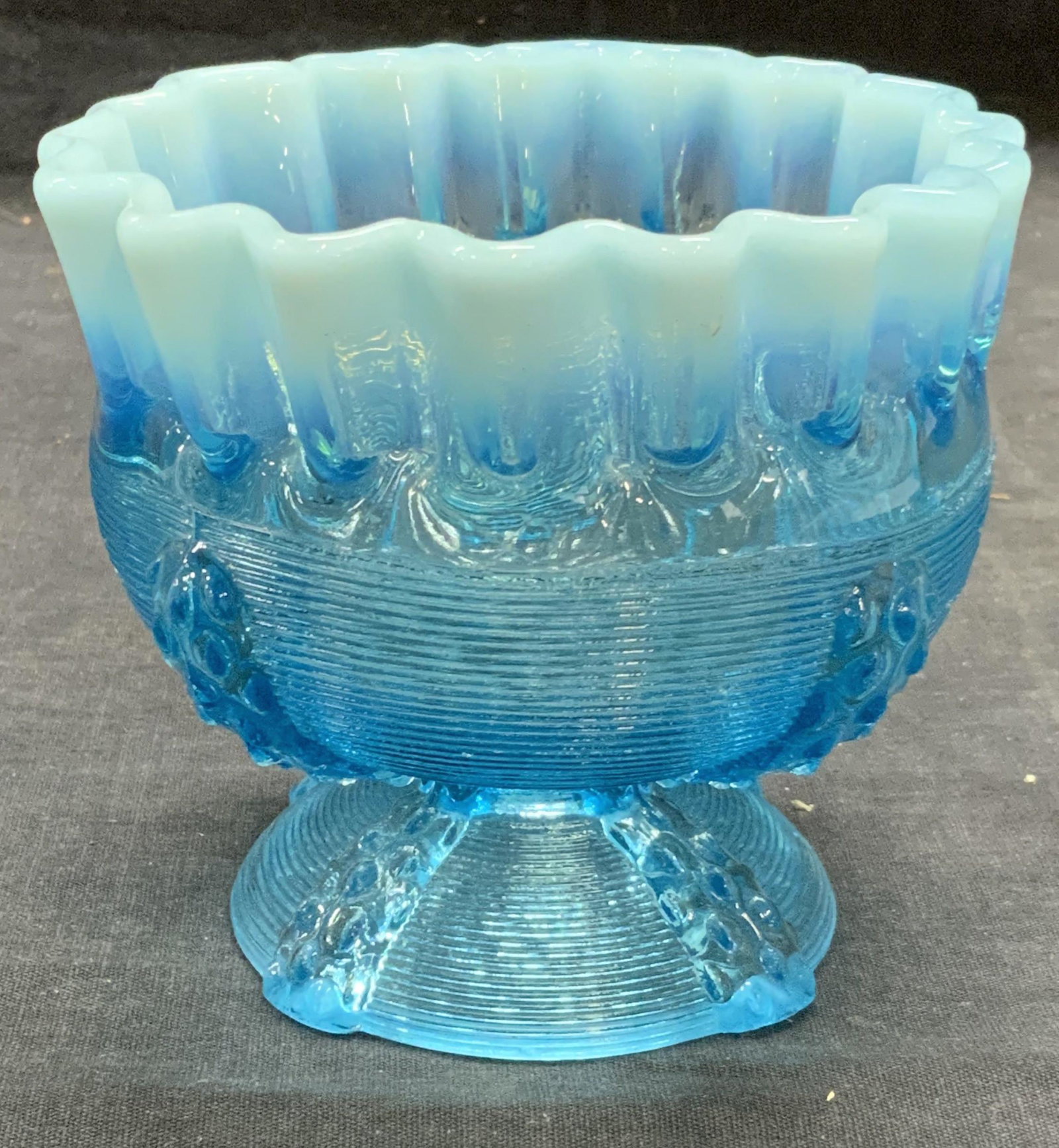 Vintage Blue Art Glass Handkerchief Bowl: Vintage blue art glass bowl with basket weave motif and handkerchief rim. Measures approx. 4.5 inches diameter and 4 inches tall. Some surface wear consistent with exposure. Art glass, art glass bowl,
