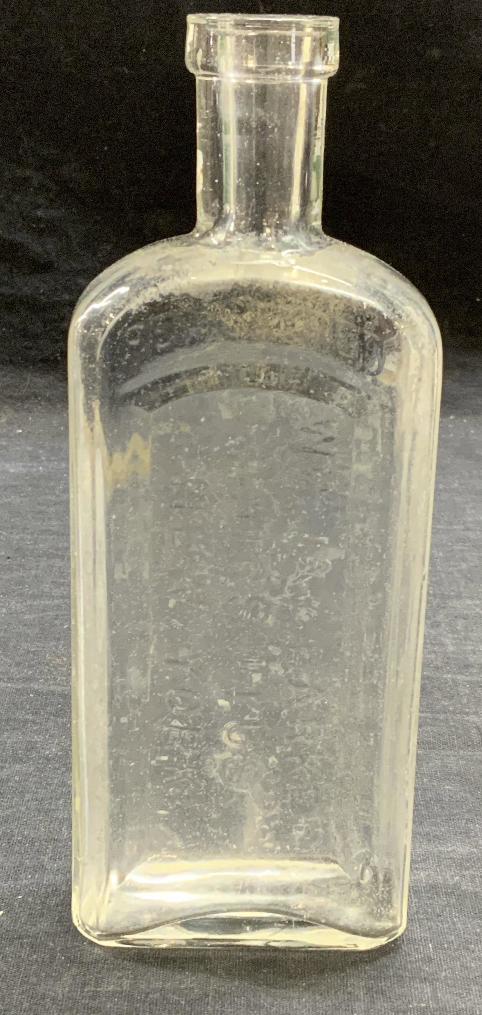 Vintage W Jay Barker Hirsutus Glass Bottle: Vintage, possibly antique, W. Jay Barker Hirsutus glass medicine bottle. Some surface wear consistent with exposure. Trademarked on bottle. Measures approx. 2.5 x 1.25 x 7 inches. Property of Manhatta
