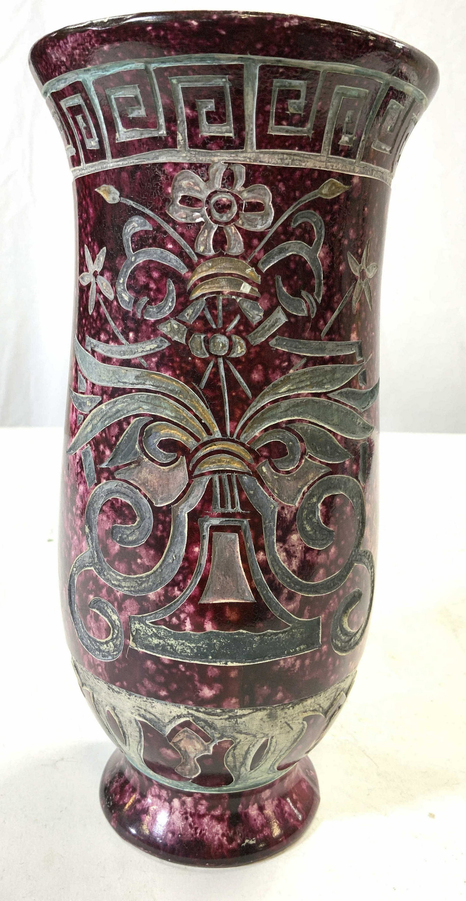 Vntg Footed Porcelain Vase Vessel: Vase is vintage. Piece appears to be porcelain possibly plaster. Vase is purple toned with specked detail. Piece has slate toned floral, leaf, geometric & curled detail. Measures approx 8.25 inches ta