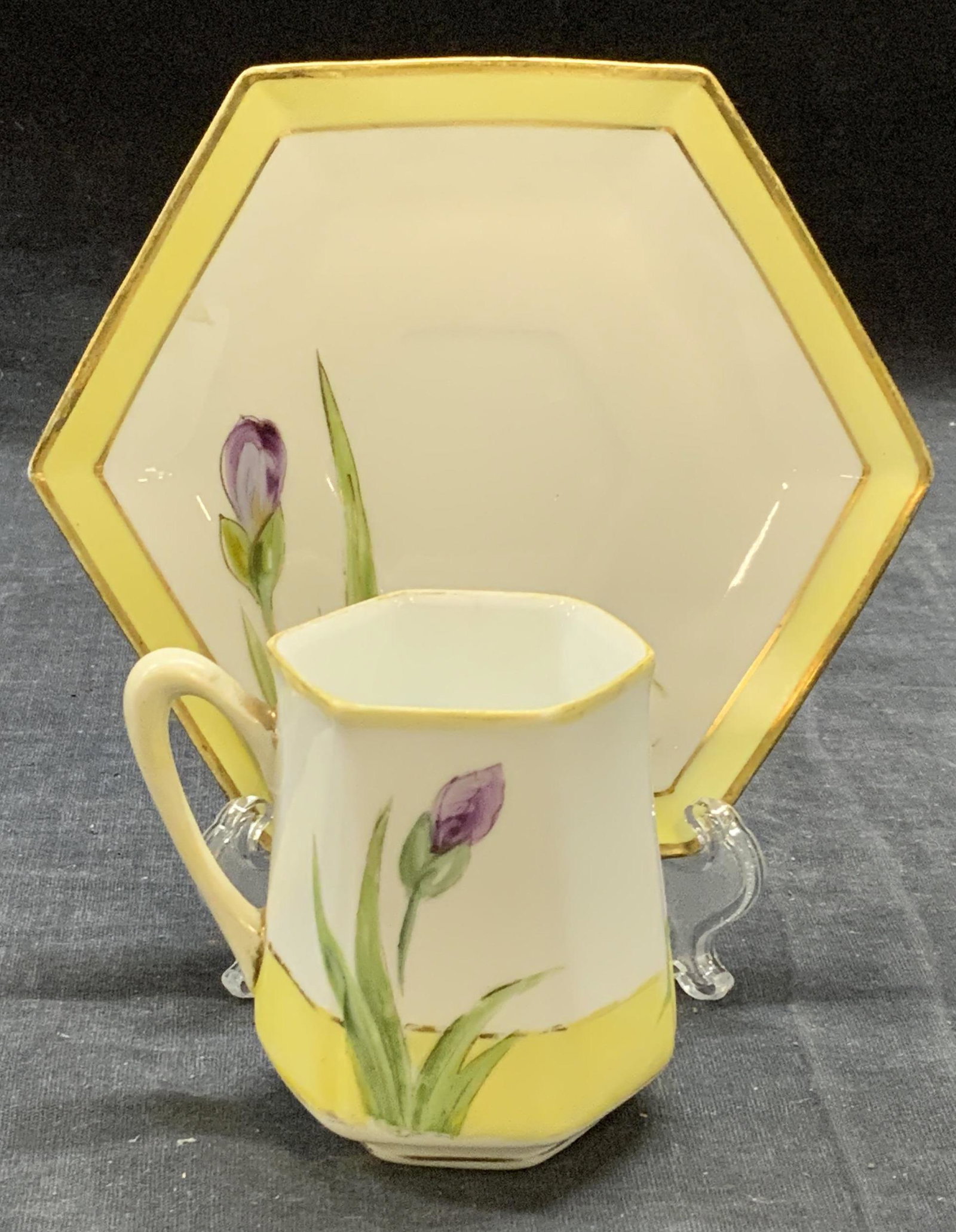 Antique Nippon Porcelain Teacup & Saucer: Antique Nippon hand painted porcelain teacup and saucer with floral motif. Trademarked to underside of teacup. Some surface wear to each consistent with exposure. Teacup measures approx. 2.25 x 2.75 i