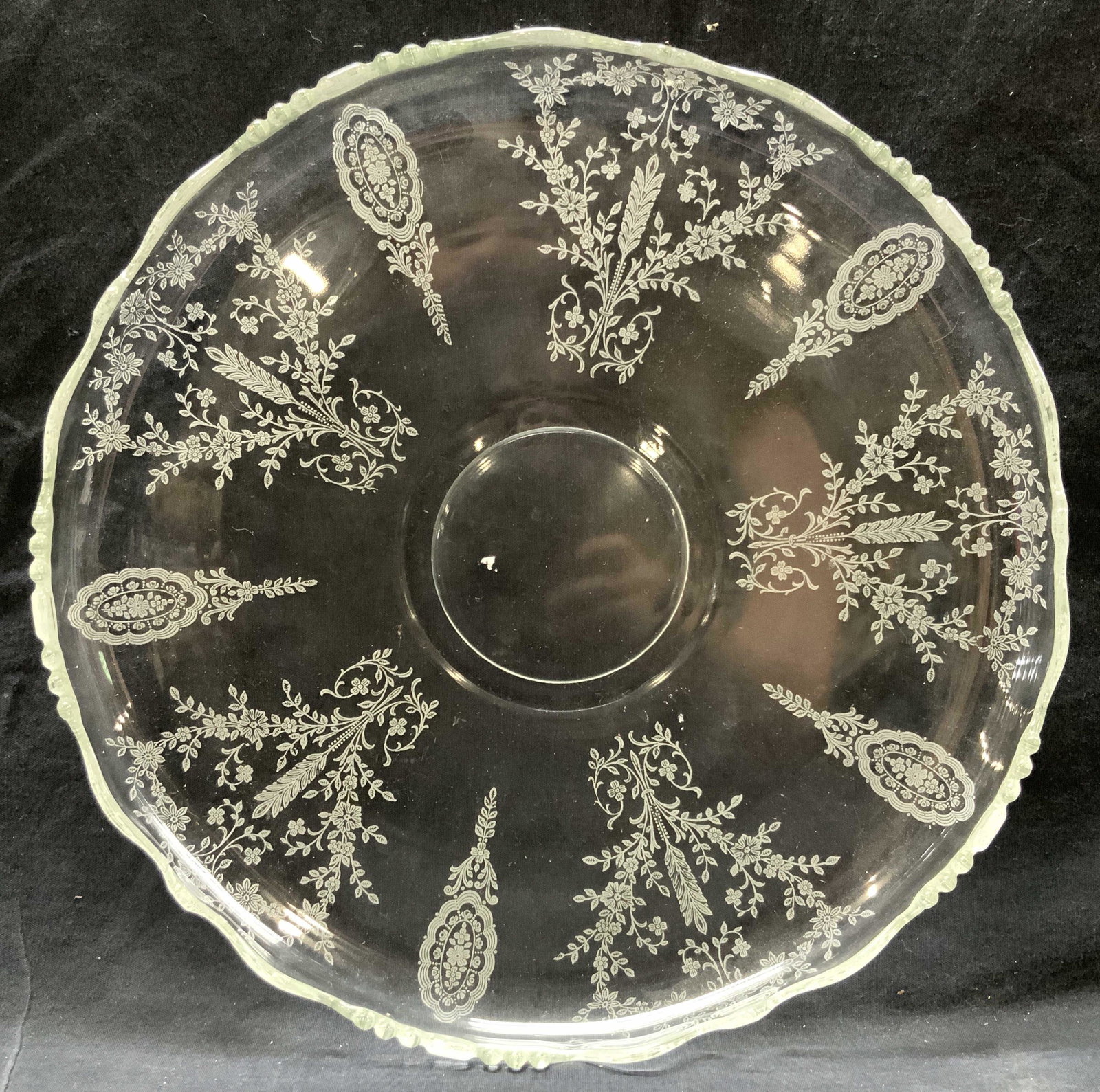 Clear Glass Floral Centerpiece Platter: Clear glass centerpiece platter with white floral underside patterns. Approximately 13 inch diameter. Minor wearing to floral patterns. Clear glass platter, centerpiece platter, tabletop accessories a
