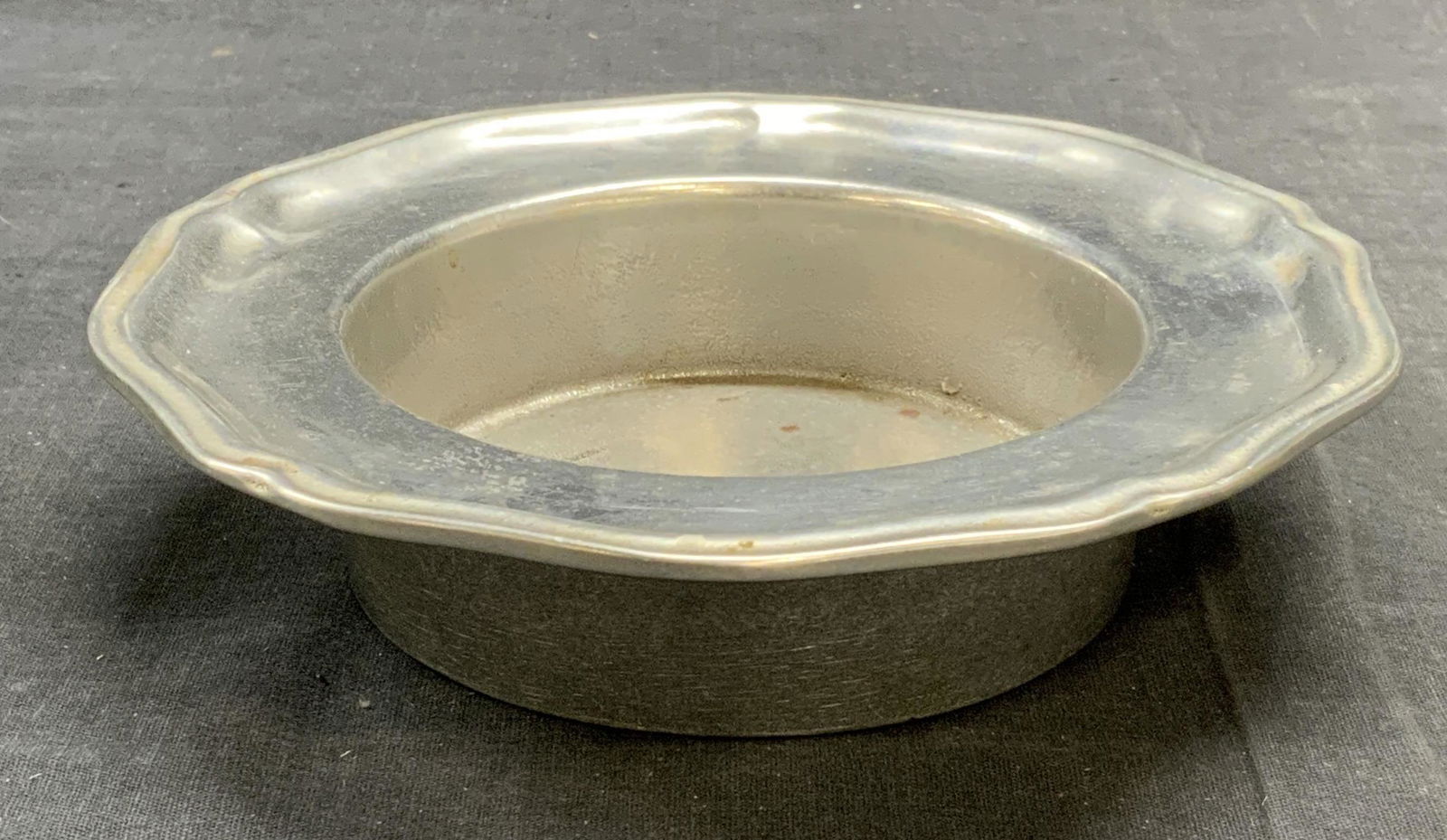 Wilton Pewter Wine Bottle Coaster: Wilton pewter wine bottle coaster. Trademarked to underside. Some surface wear consistent with exposure. Measures approx. 7 x 1.75 inches. Wilton, Wilton wine bottle coaster, pewter wine bottle coaste