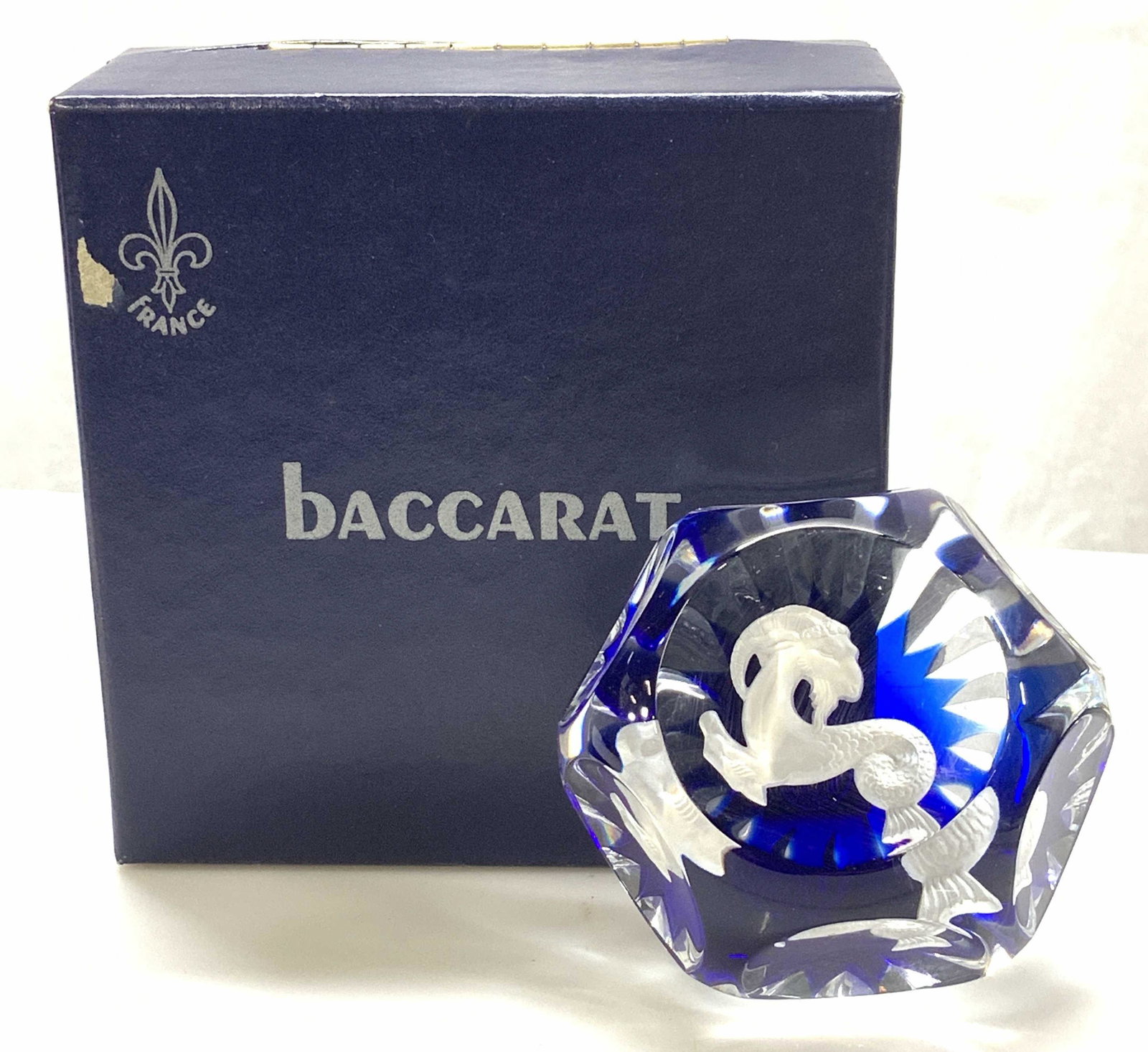 BACCARAT France Zodiac Crystal Paperweight: Baccarat France Crystal ZODIAC Capricorn the GOAT paperweight, cobalt blue colored crystal illuminates the sulphide goat which seems to float within the crystal. Faceted semi- circle cut crystal paper