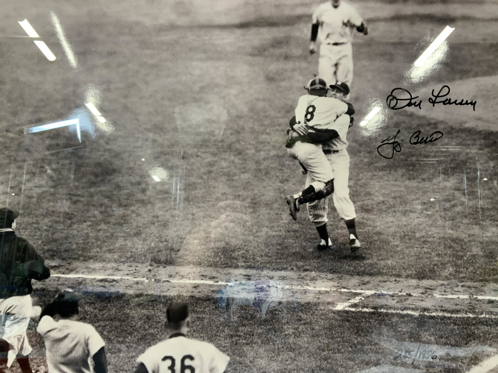 Signed Berra & Larson NY Yankees Photograph: Framed photographs of Don Larson and Yoggie Berra celebrating a perfect game on mound, 1956.Photograph is signed on upper right corner by both Berra and Larson and is marked 285/1956.Framed in gold to