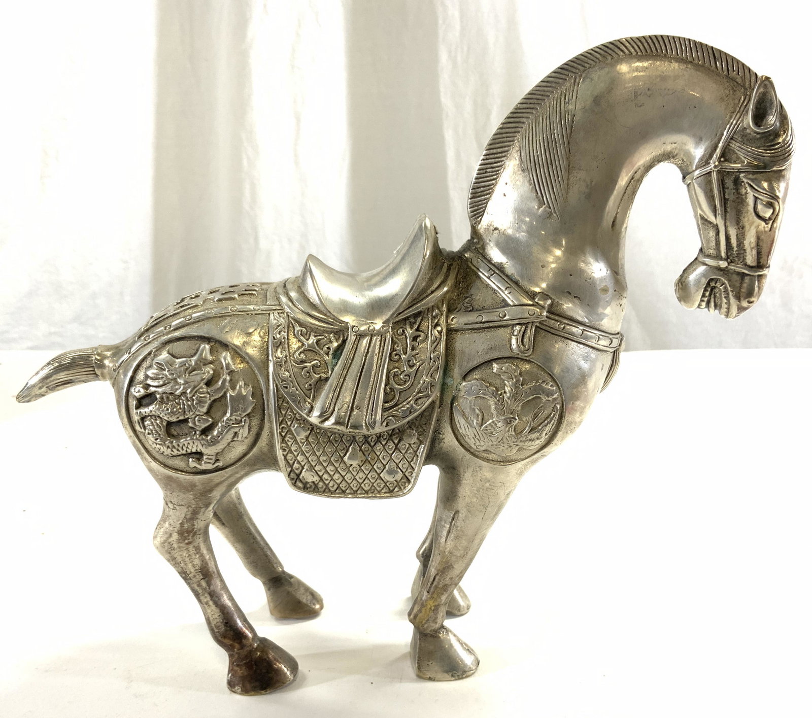 Vntg Asian Silvered Brass Horse Sculpture: Horse sculpture is silvered brass. Piece depicts horse with saddle, dragon & geometric detail. Sculpture measures approx 10 inches deep 8.75 inches tall 3.25 inches wide. Horse sculpture, horse figura