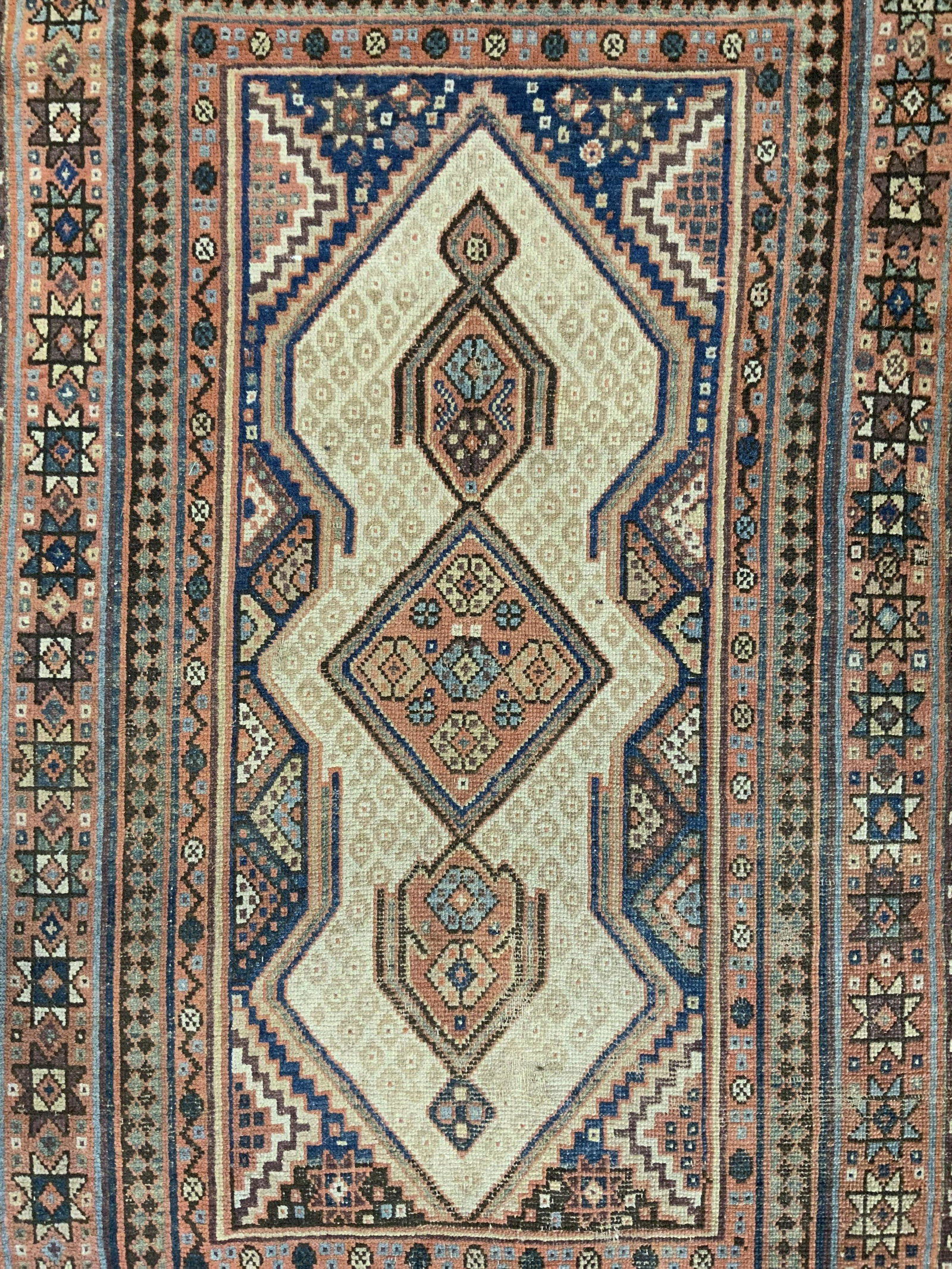 Vintage Handmade Turkish Wool Rug: Rug is handmade and wool. Piece is vintage possibly antique. Rug has intricate multi toned geometric detail. Piece has short sand toned fringes. Rug measures approx 71 inches long 44 inches wide. Rug,